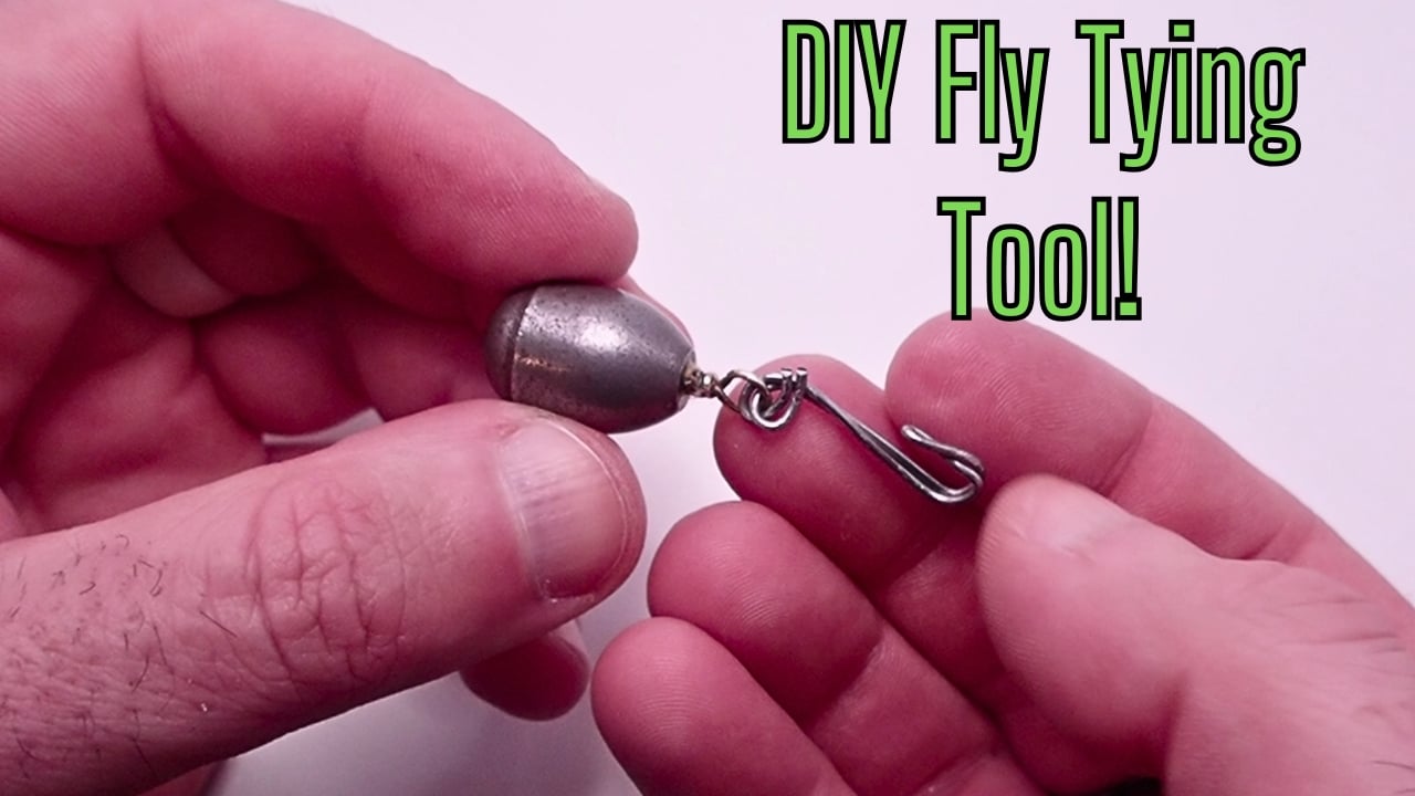 Close-up of a DIY dubbing loop spinner built from a steel bass casting sinker and a paperclip, for budget fly tying.