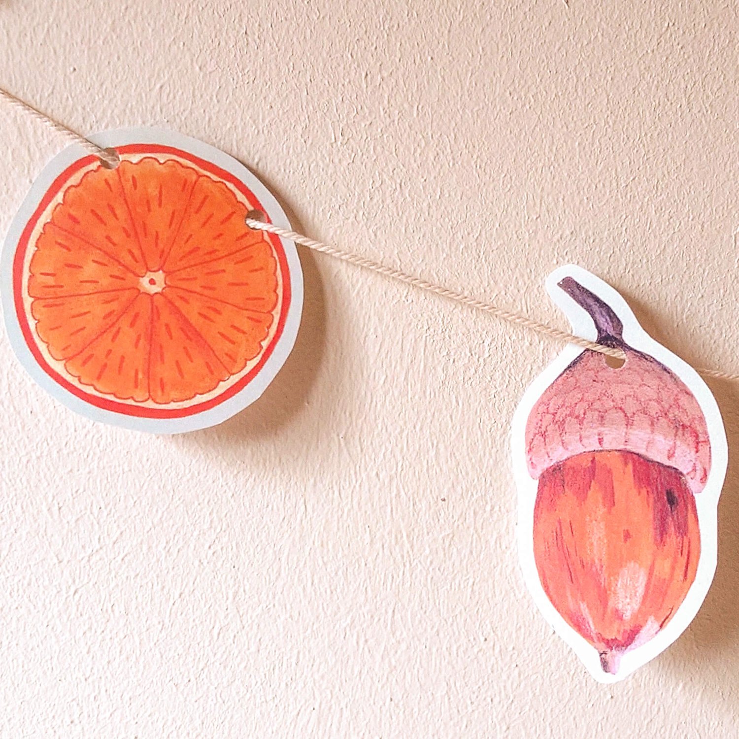 paper orange slice and acorn on string