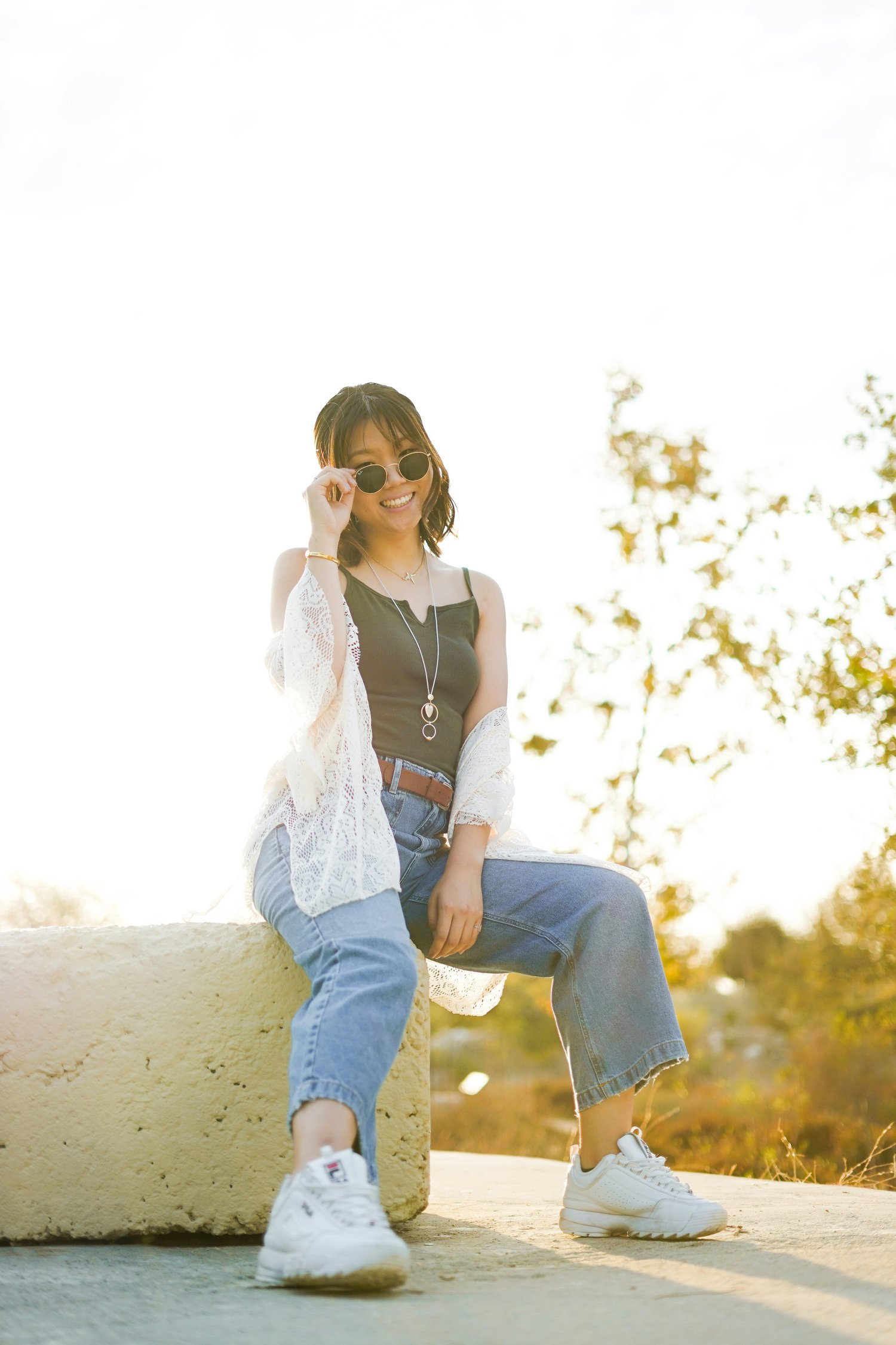 https://unsplash.com/photos/smiling-woman-wearing-black-spaghetti-strap-top-and-blue-denim-jeans-sitting-about-to-take-off-her-sunglasses-E8Ux7f7NhQM?utm_content=creditShareLink&utm_medium=referral&utm_source=unsplash