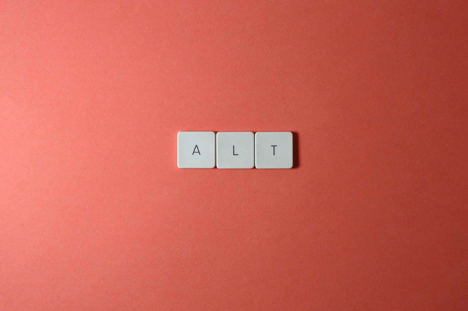 keyboard letters spell ALT on a peach colored background
