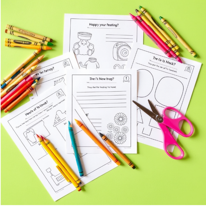 Bright and playful flat-lay of printed worksheets, crayons, and scissors.
