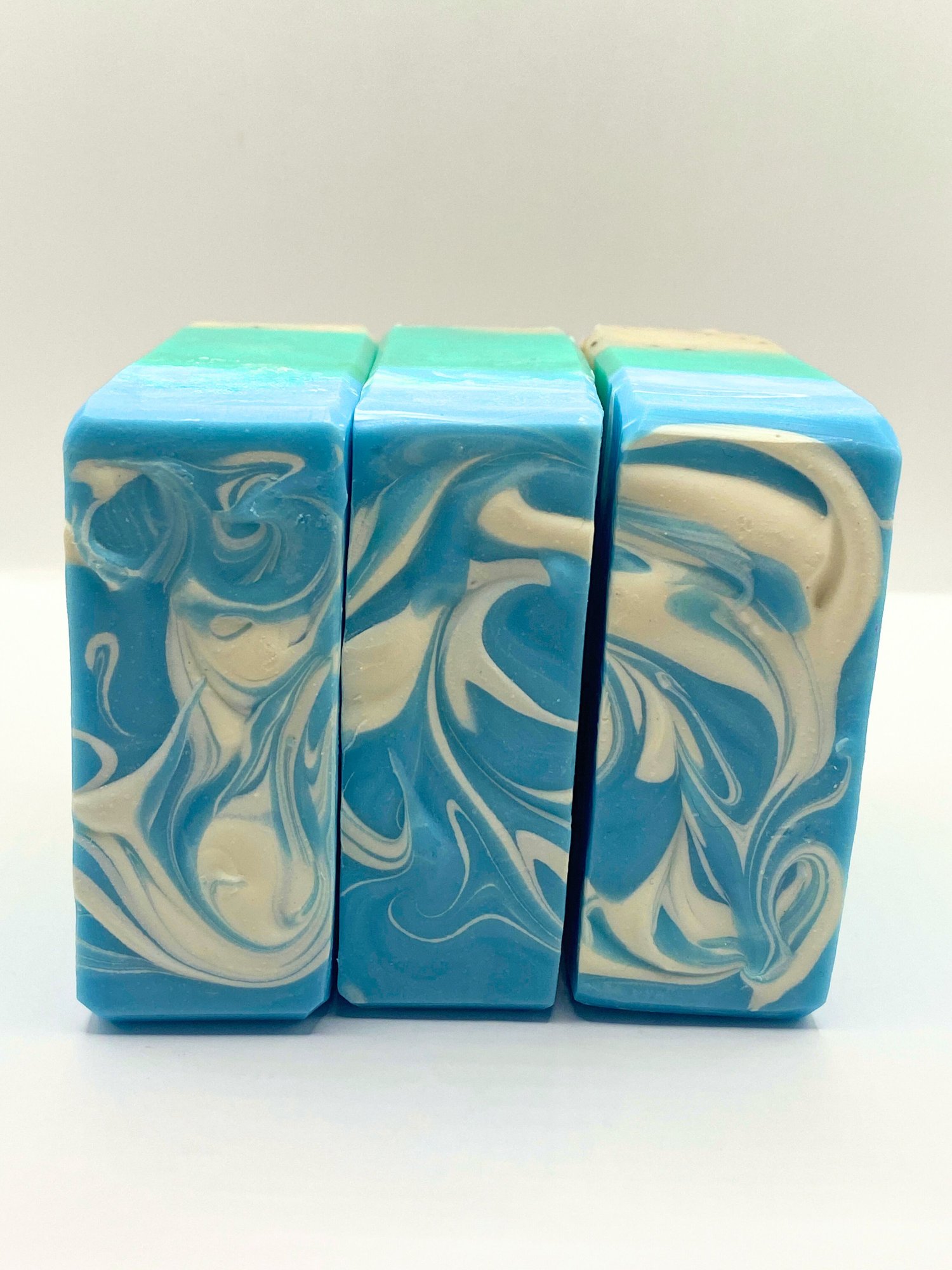 Three bars of handmade Palm Beach soap showing the swirled tops