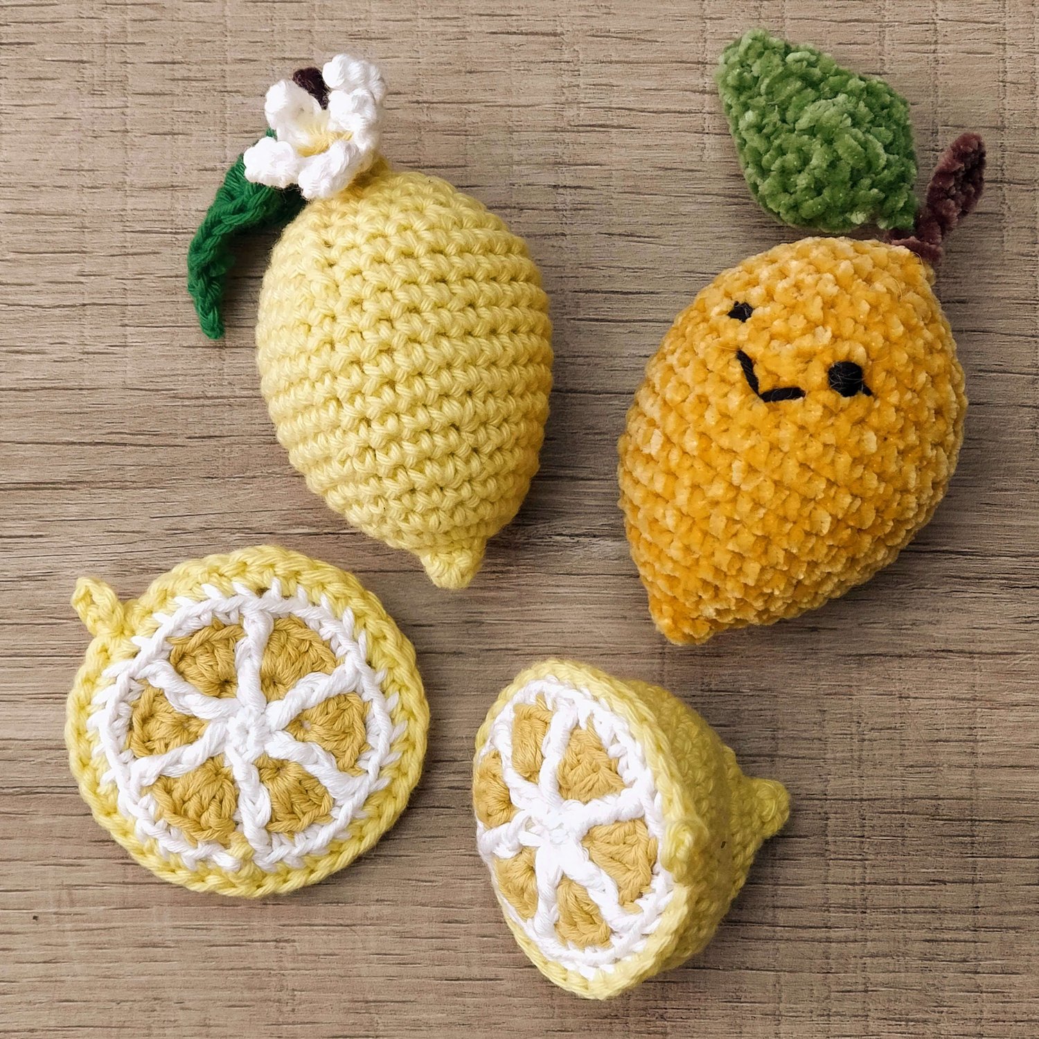 Crocheted lemon with kawaii faces plus a lemon slice and a lemon half