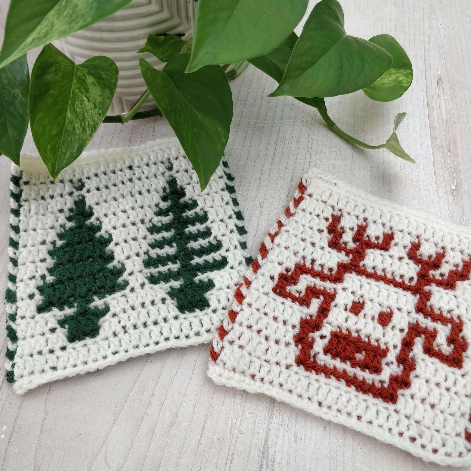 Crochet square motifs showing a reindeer head and two fir trees