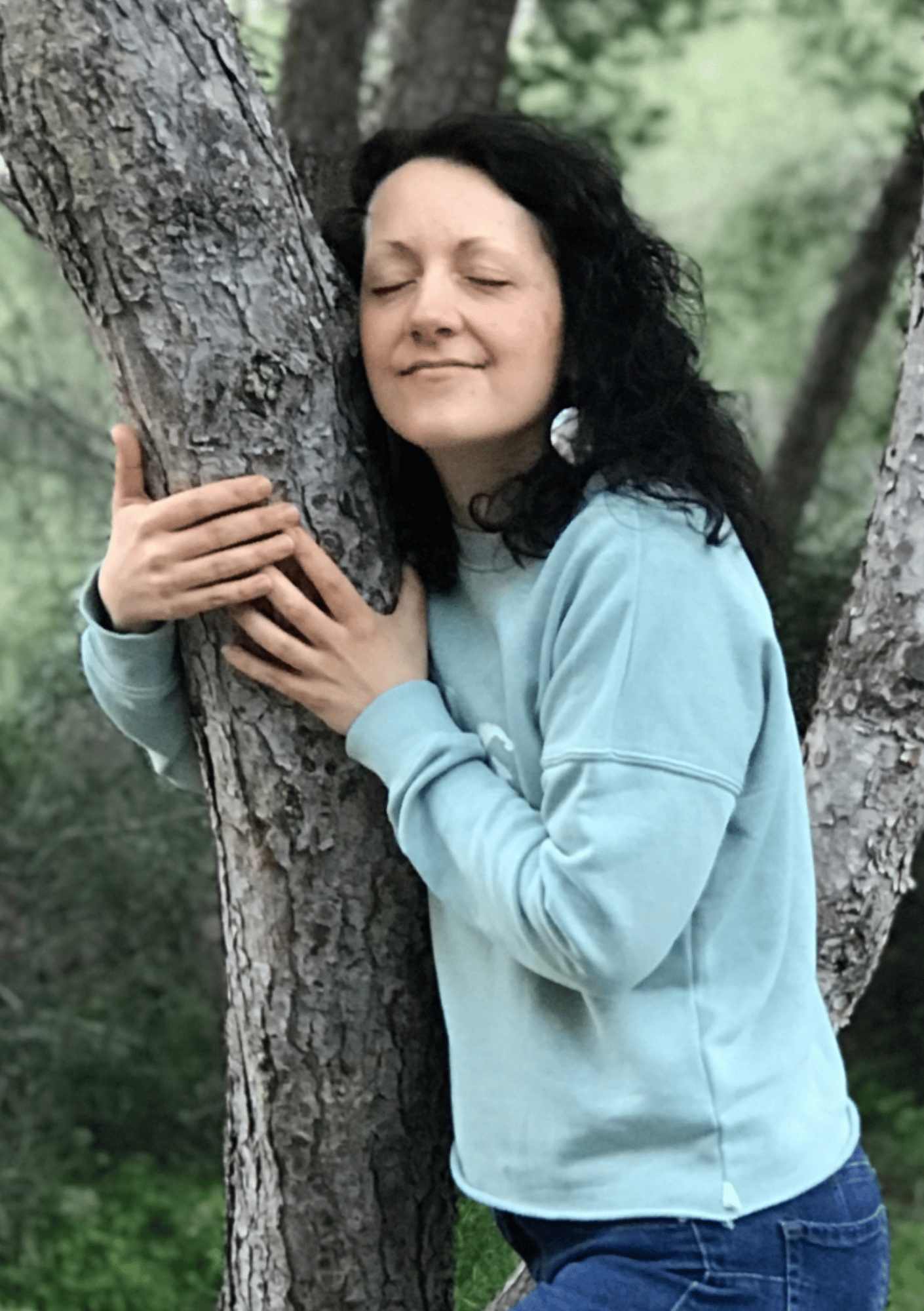 Isabel Bar embracing a tree in a peaceful forest setting, symbolizing connection with nature and soulful guidance — Work With Me page on iamisabelbar.com