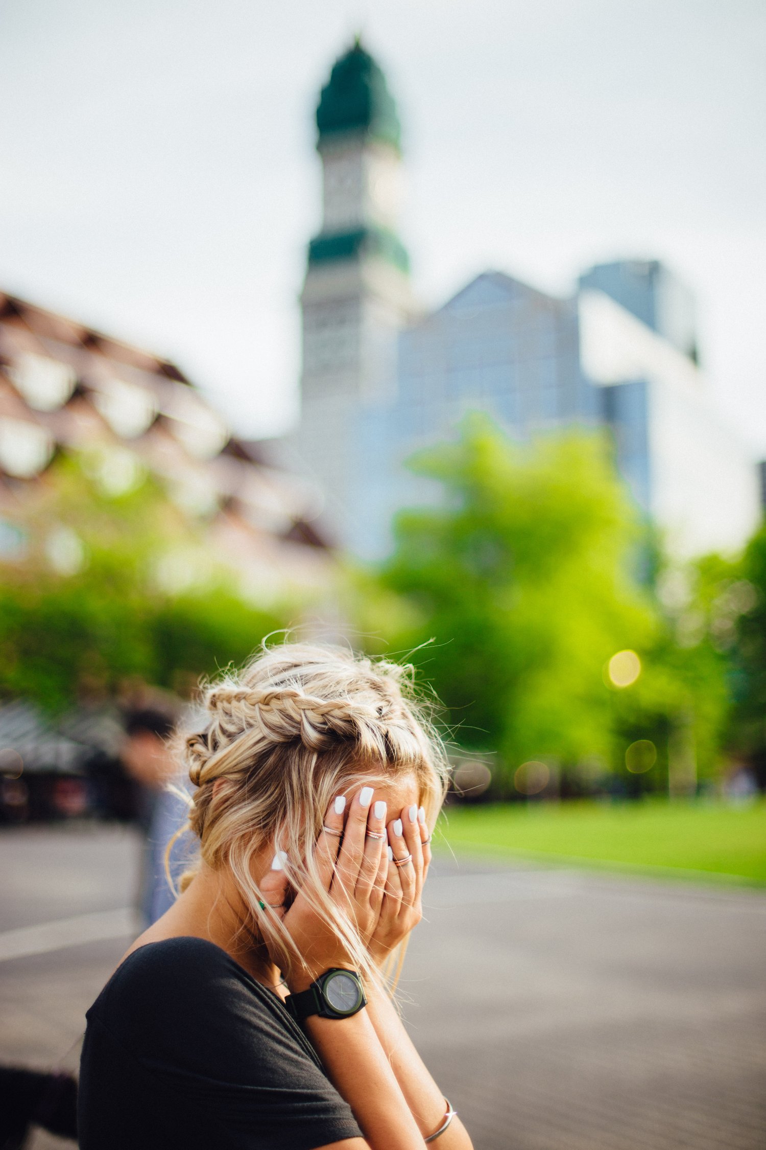 Woman hides her face in her hands
