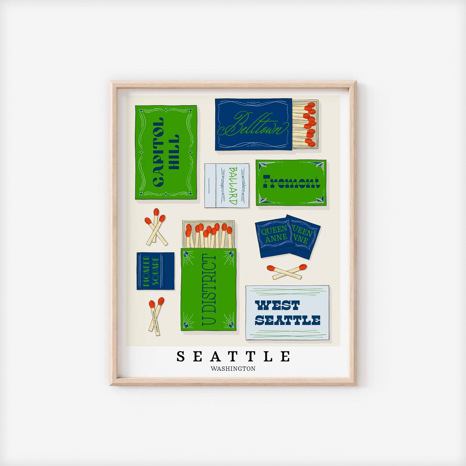 A framed picture of Seattle, Washington neighborhoods drawn in various lettering styles on matchboxes. Artwork has a bright green and blue color scheme