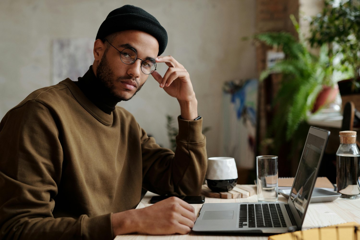 A young man working in his home office