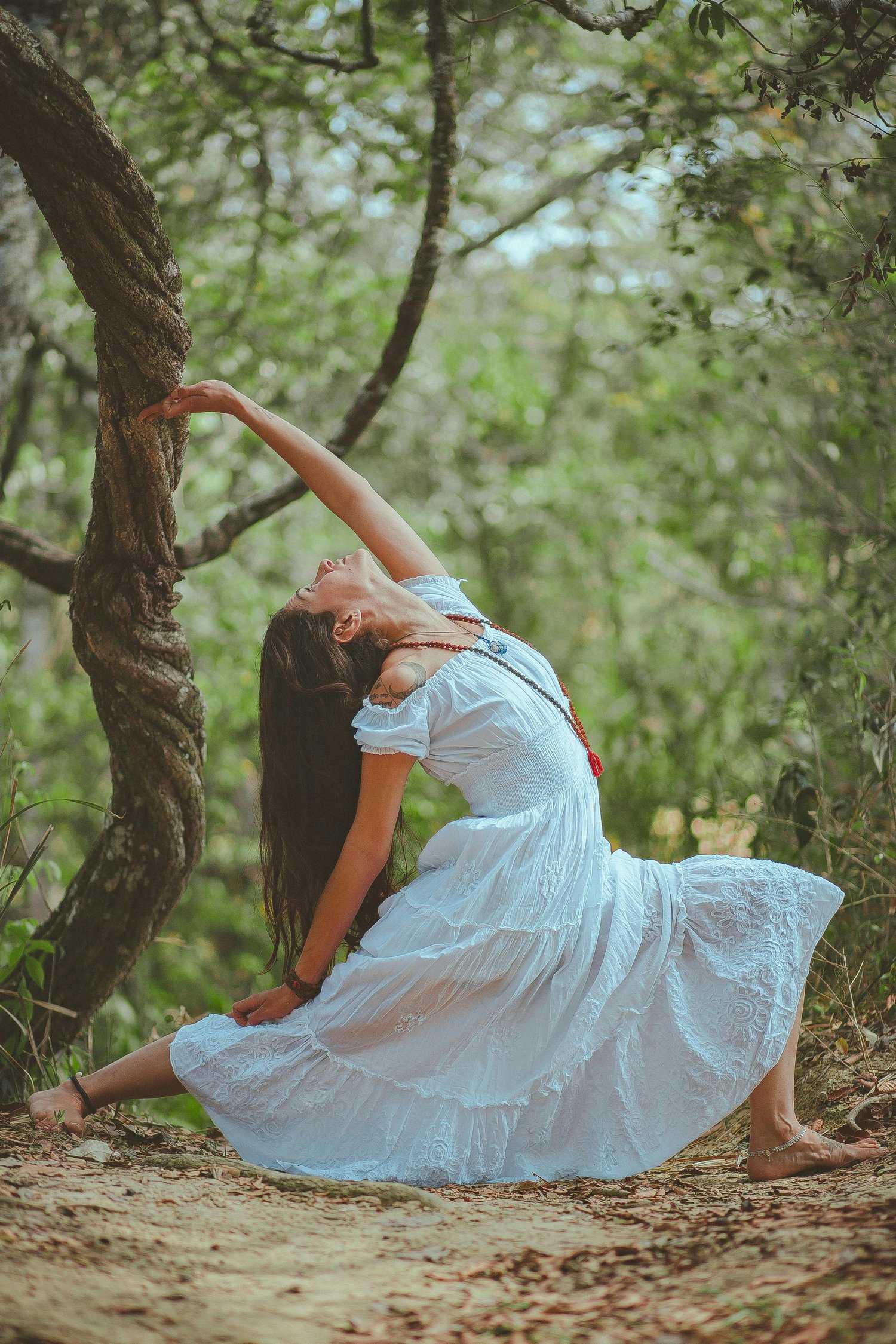 woman in forest in warrior pose