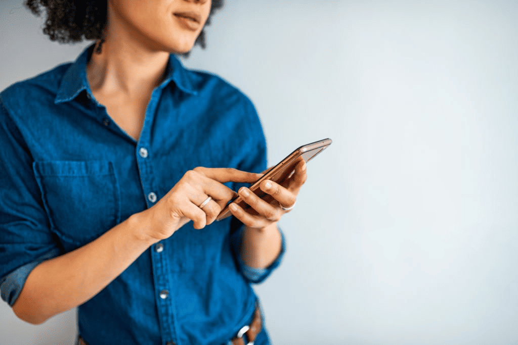 woman looking at her phone for voxer coaching