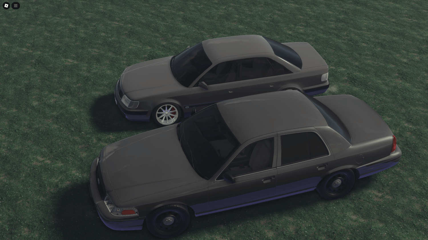 Front view of two regular gray vehicles with a basic design.