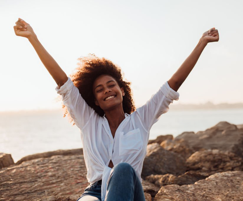 woman smiling arms in the air in triump