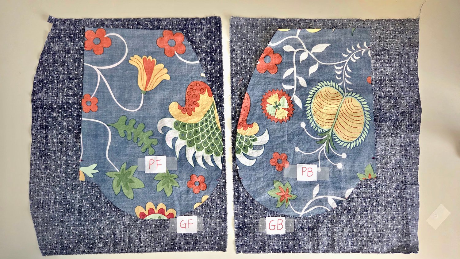 Four pieces of fabrics laid out on the table, marked PF, PB, GF, and BG.
