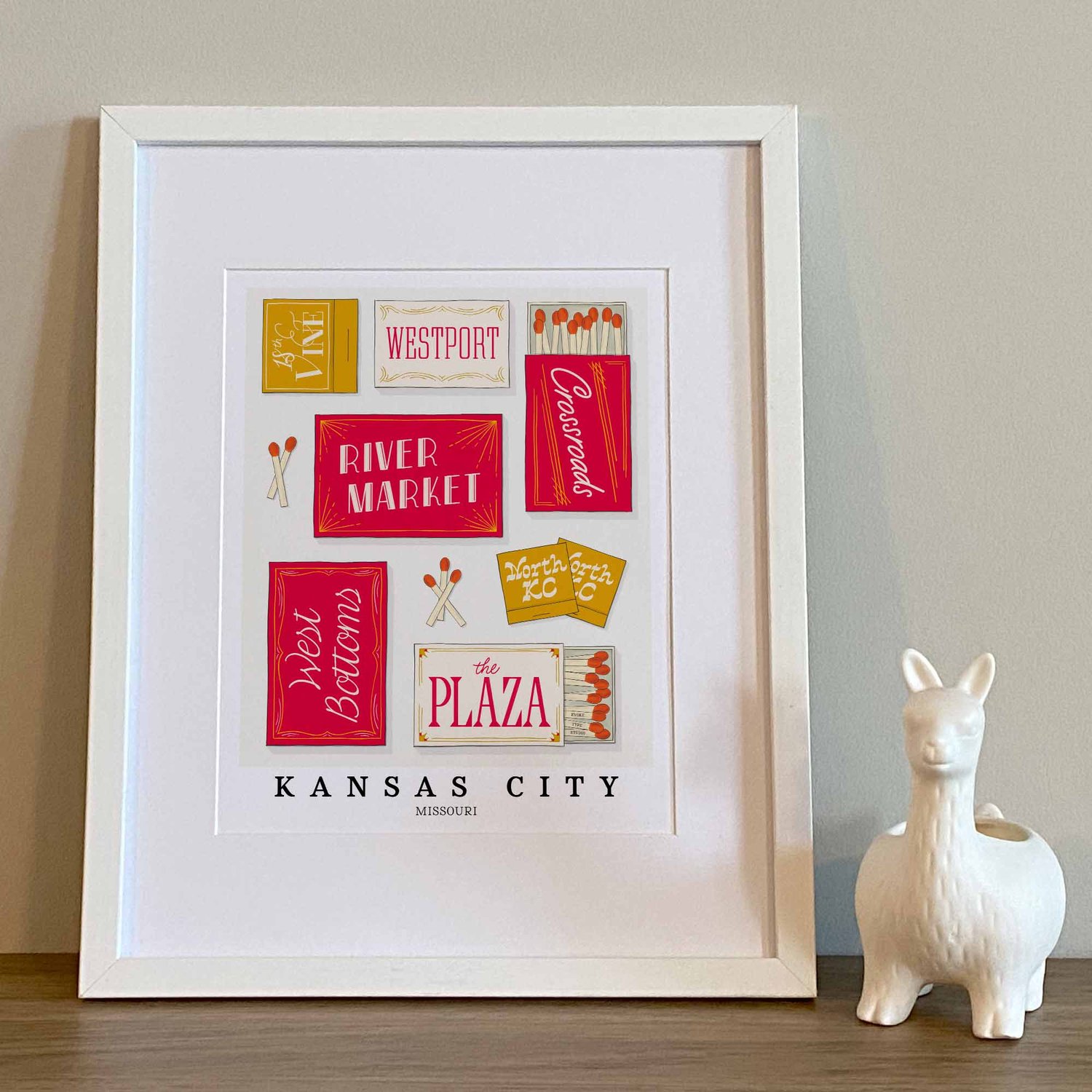 Hand-drawn Kansas City matchbox wall art featuring custom lettering in red, gold, and white tones