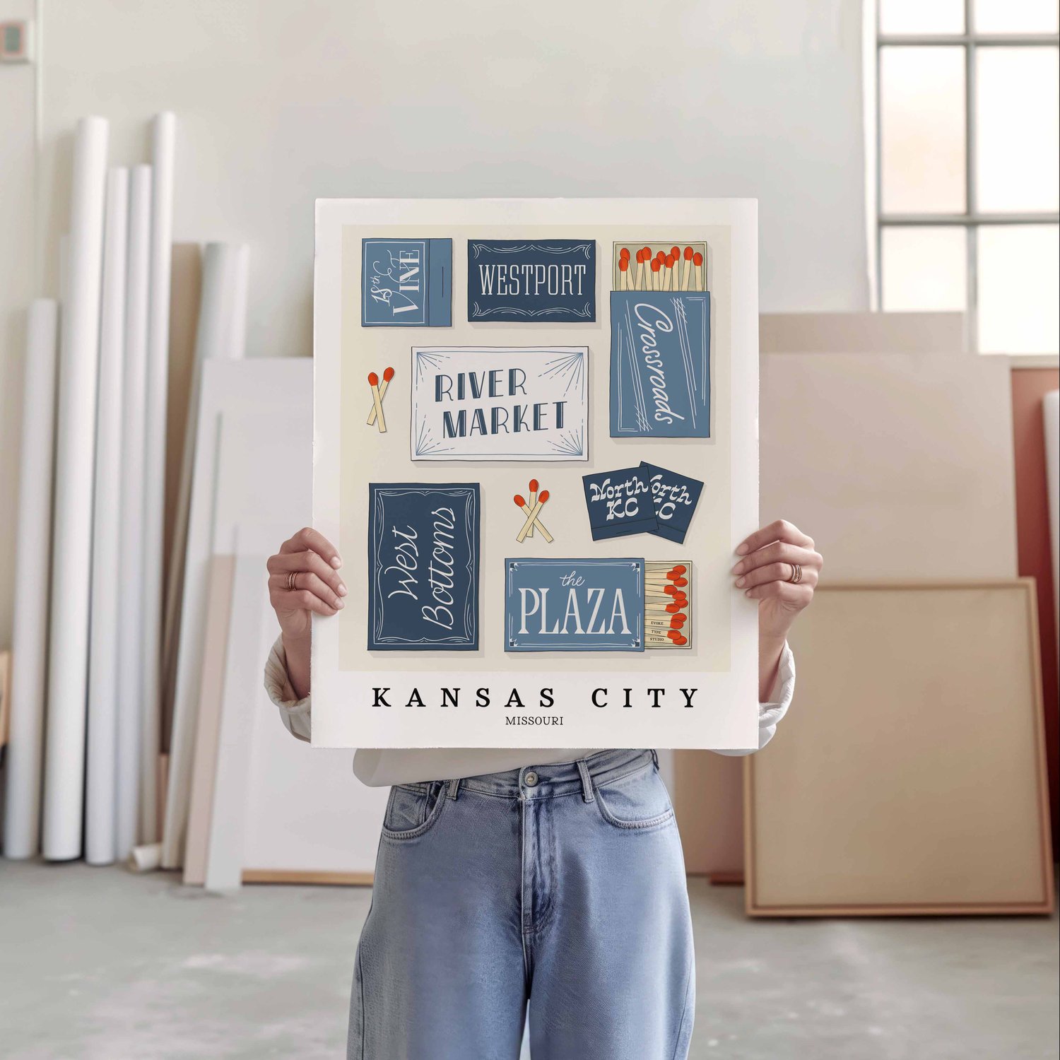 A person holding a poster of several matchboxes