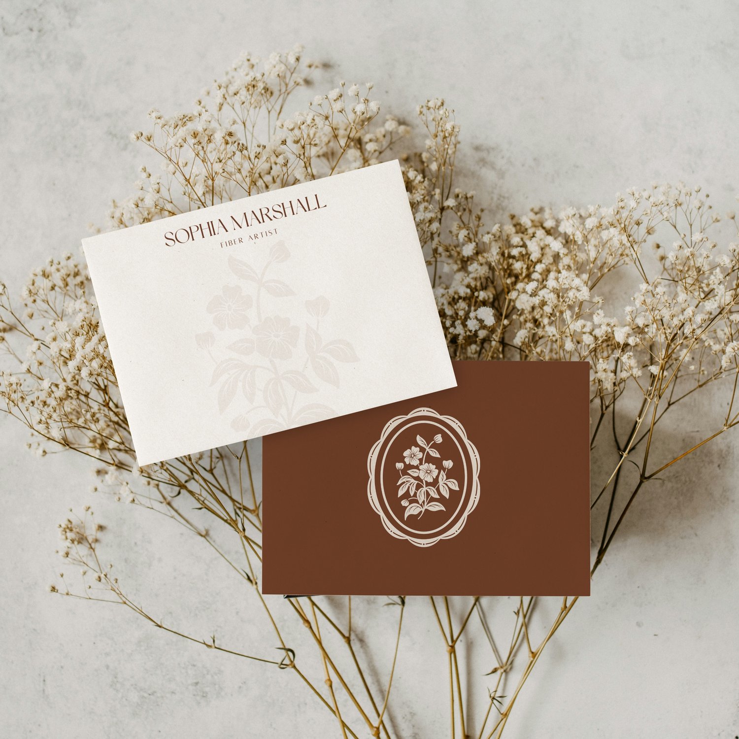 Logo design featuring hand drawn illustration of wildflowers in a scalloped frame that says Sophia Marshall Fiber Artist