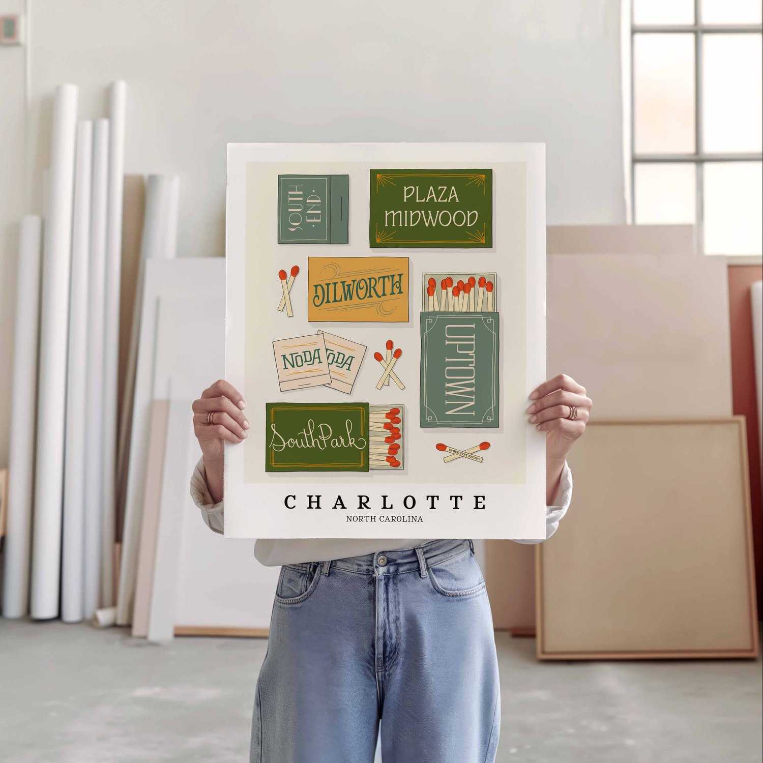A person holding a poster of several matchboxes