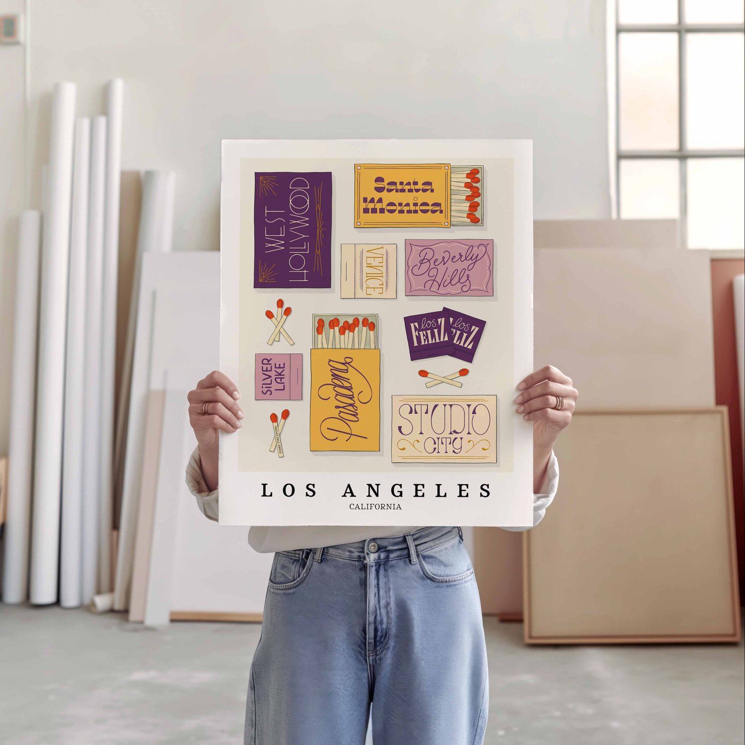 A person holding a poster of several matchboxes
