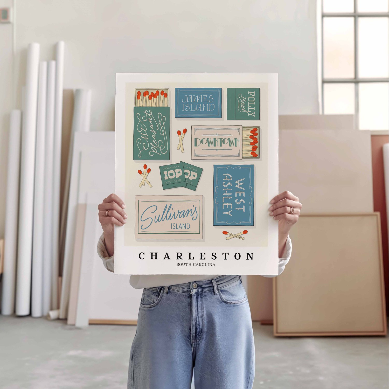 A person holding a poster of several matchboxes