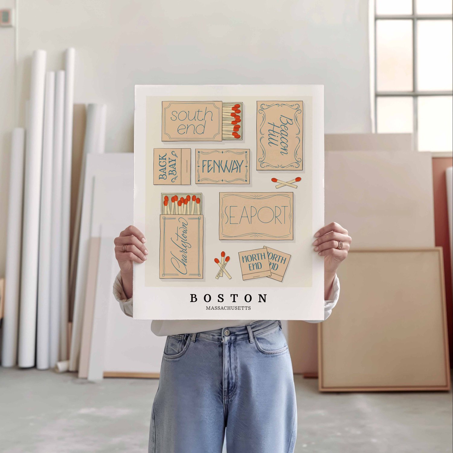 A person holding a poster of several matchboxes