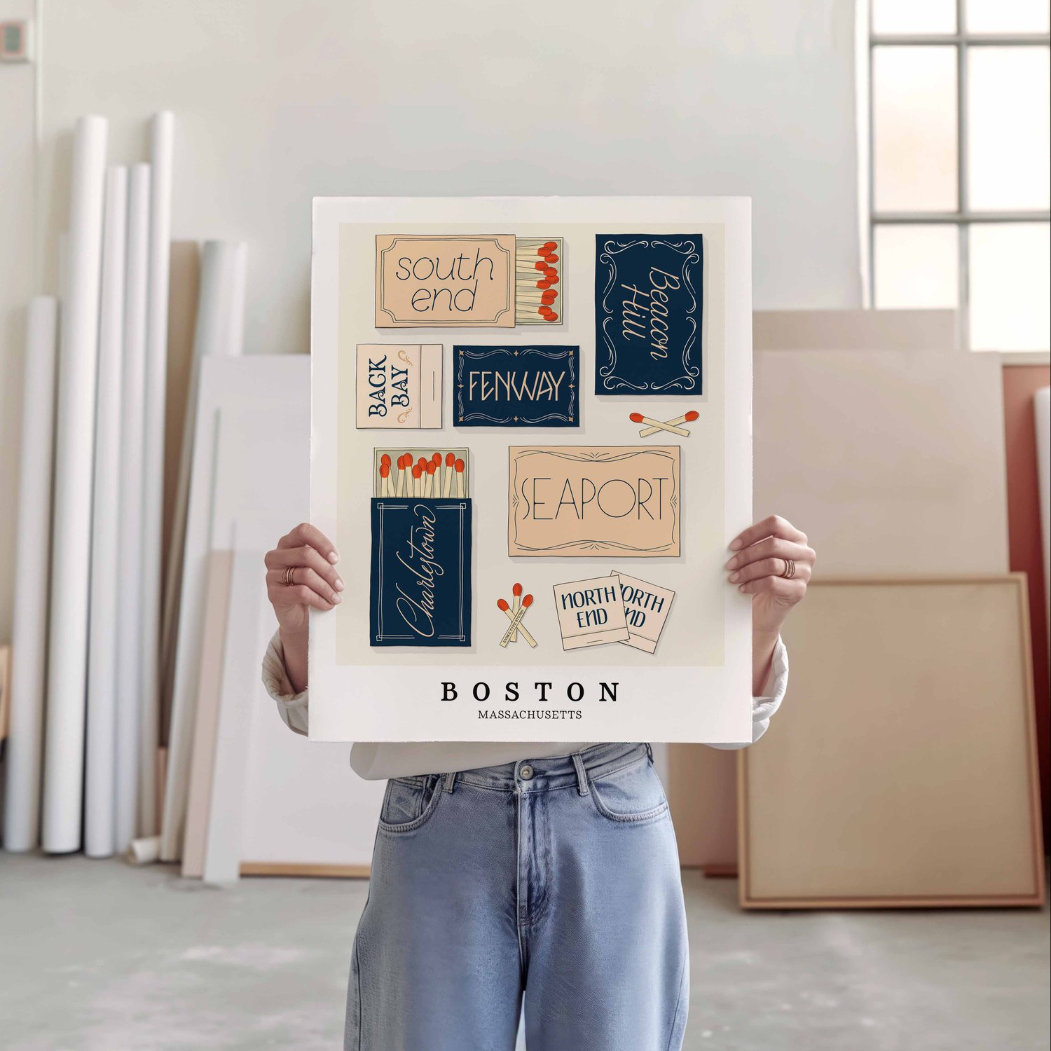 A person holding a poster of several matchboxes