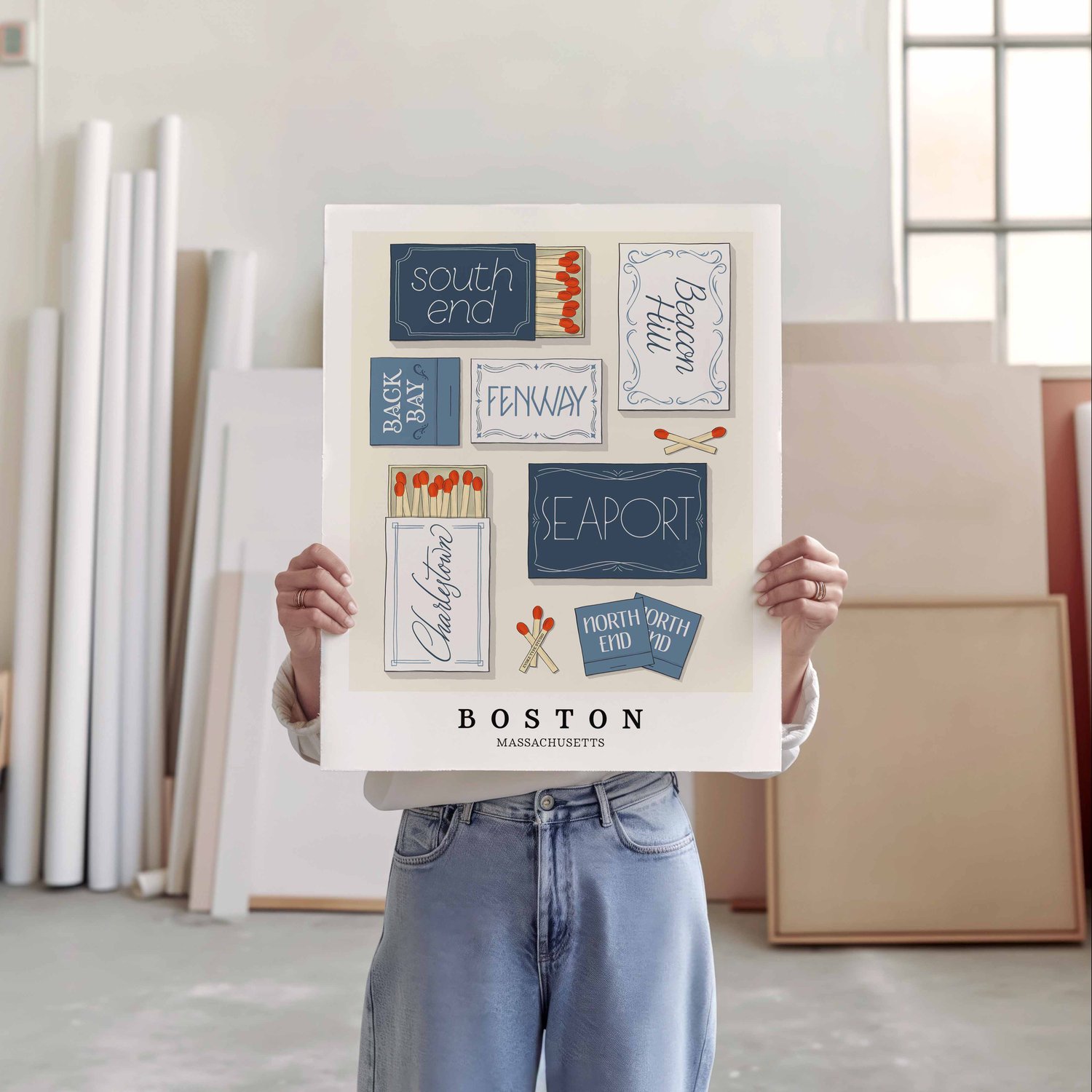 A person holding a poster of several matchboxes