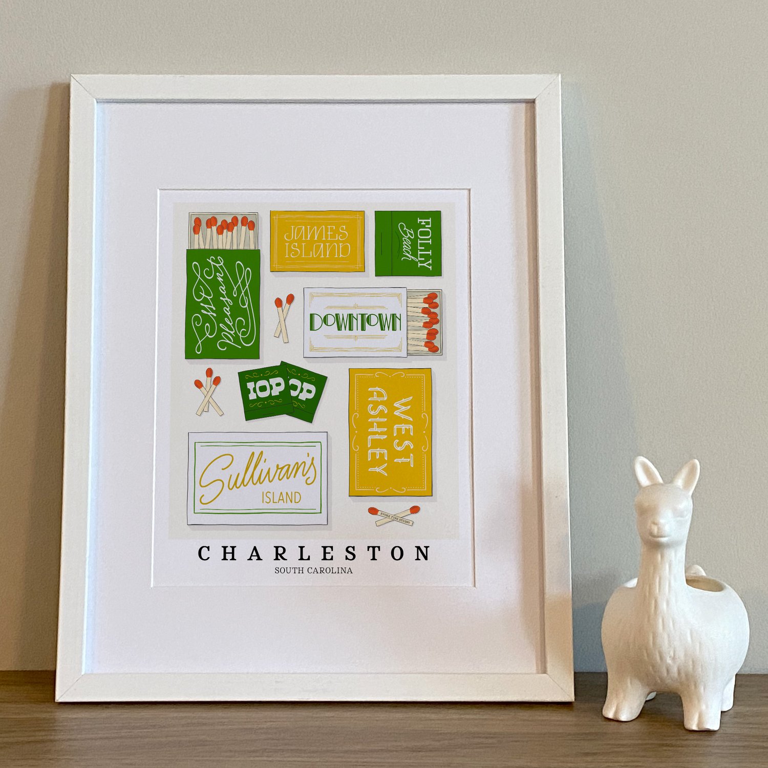 Hand-drawn Charleston matchbox wall art featuring custom lettering in white, green, and yellow tones