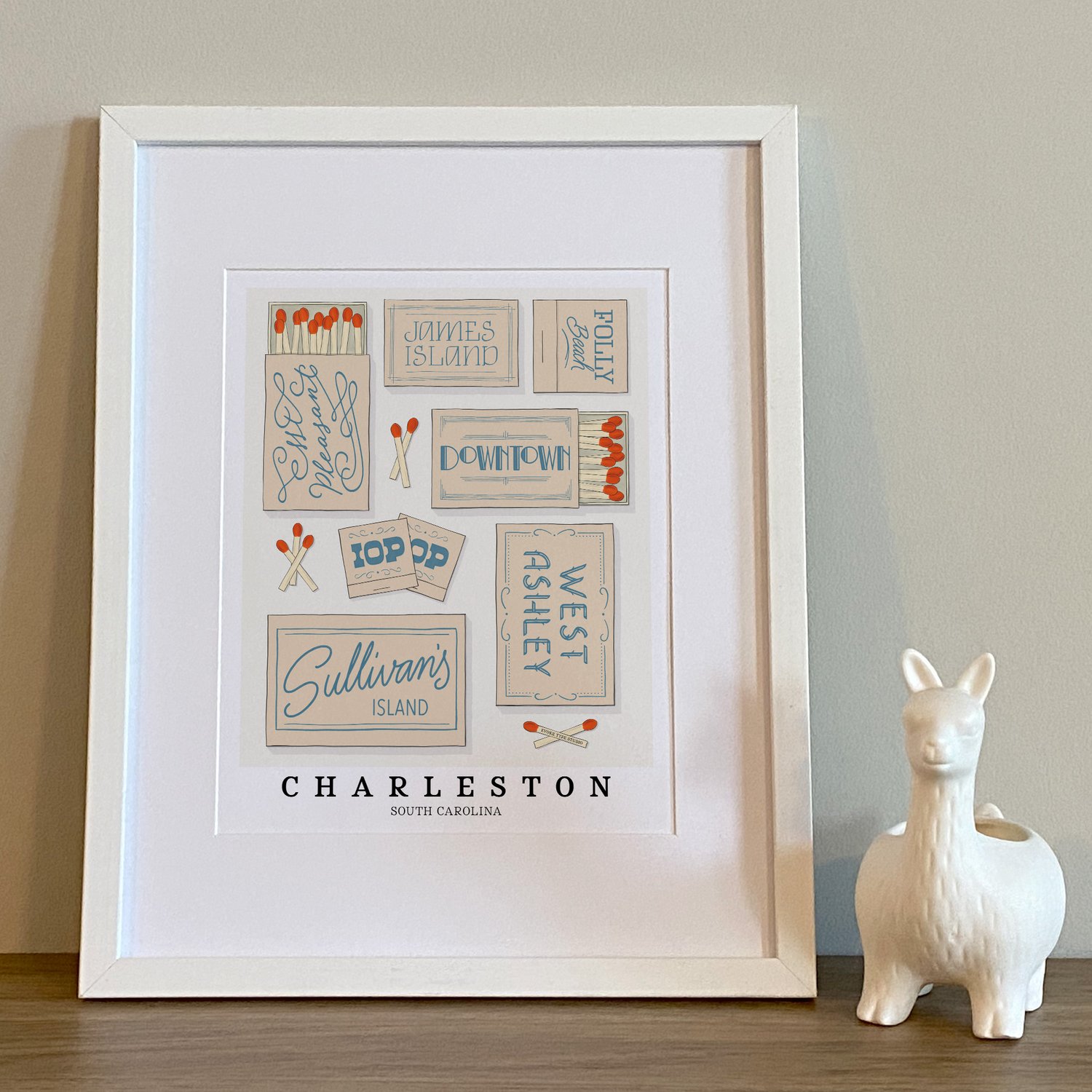 Hand-drawn Charleston matchbox wall art featuring custom lettering in calming beige and blue tones
