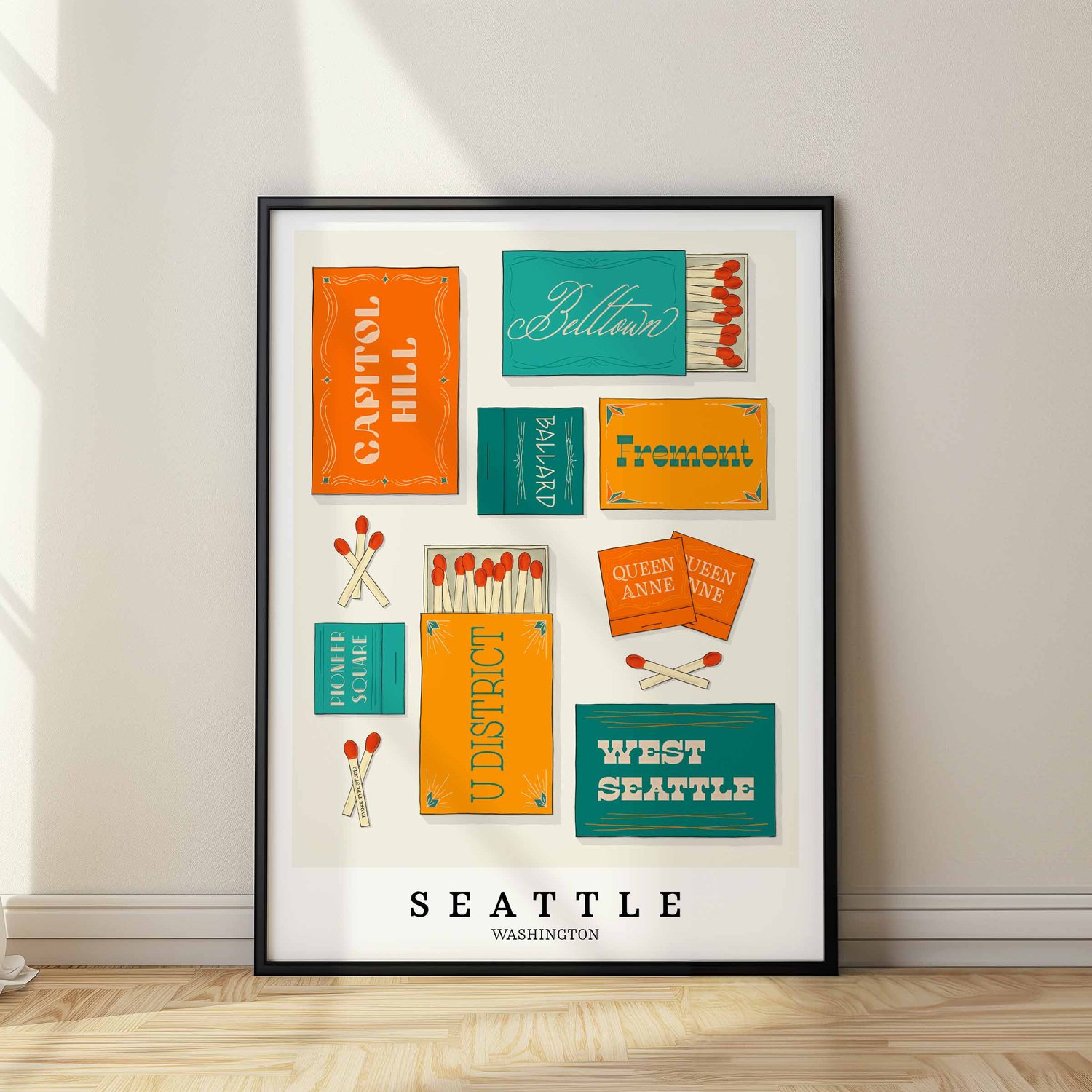A framed picture of Seattle, Washington neighborhoods drawn in various lettering styles on matchboxes. Artwork has a orange, blue and yellow color scheme