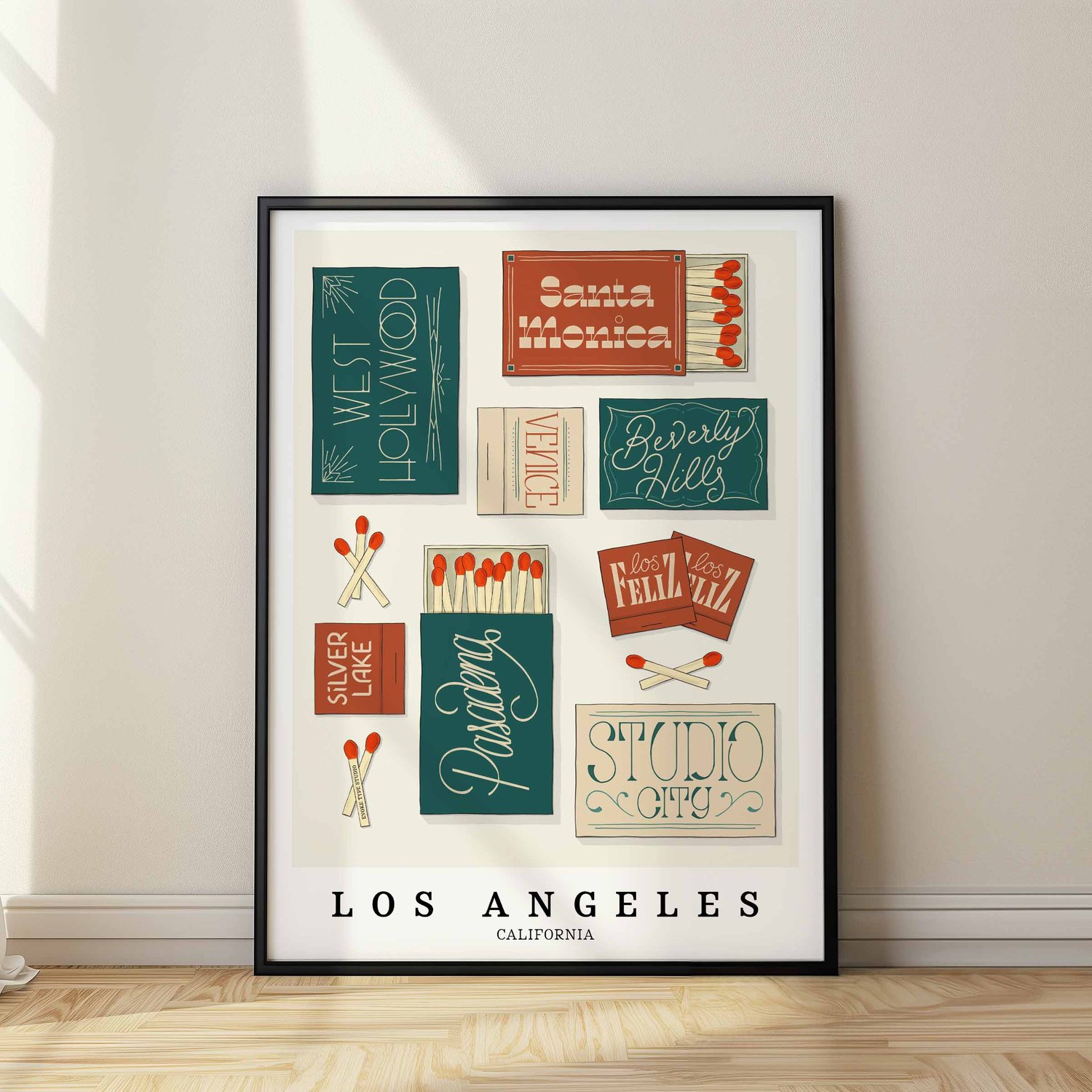 A framed picture of Los Angeles, California neighborhoods drawn in various lettering styles on matchboxes. Artwork has a green, orange and tan color scheme