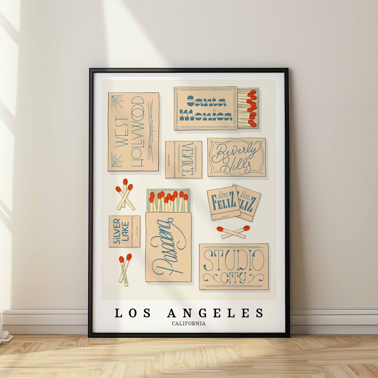 A framed picture of Los Angeles, California neighborhoods drawn in various lettering styles on matchboxes. Artwork has a beige and blue color scheme