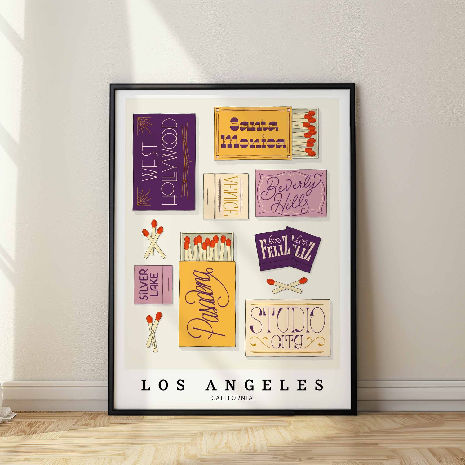 A framed picture of Los Angeles, California neighborhoods drawn in various lettering styles on matchboxes. Artwork has a purple and yellow color scheme