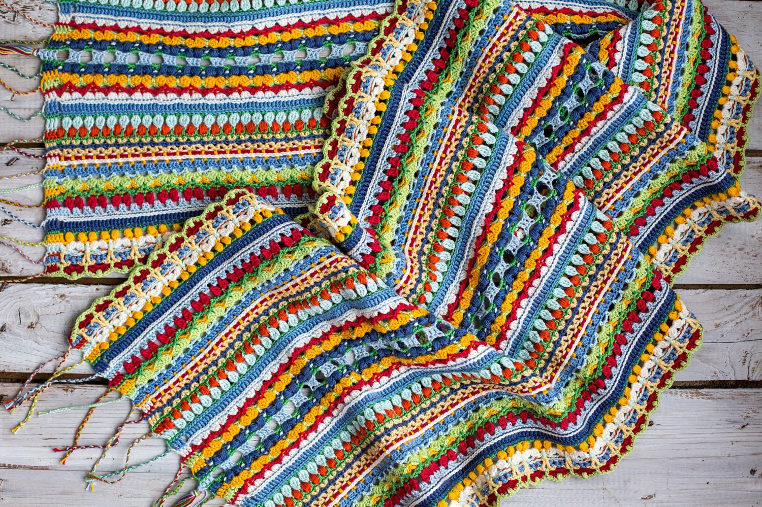 This large, rectangular crochet scarf is bursting with color and personality — perfect DIY project for anyone who misses the vibrant feel of summer during fall and winter.