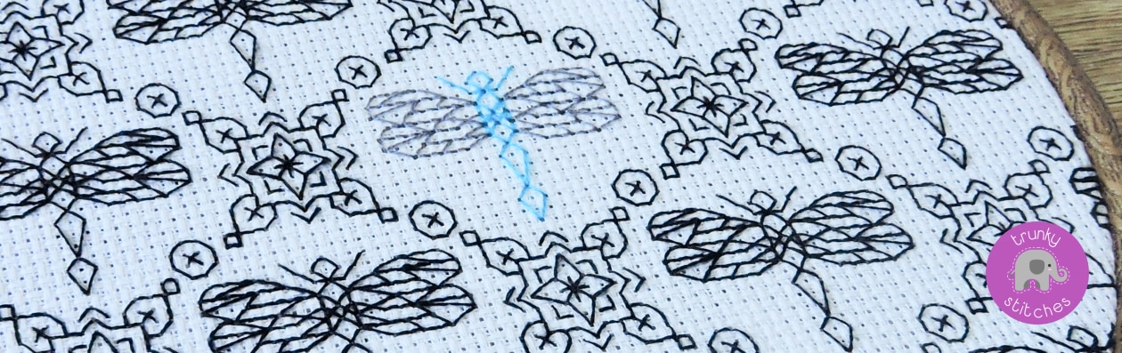 A stitched blackwork embroidery design of geometric dragonflies
