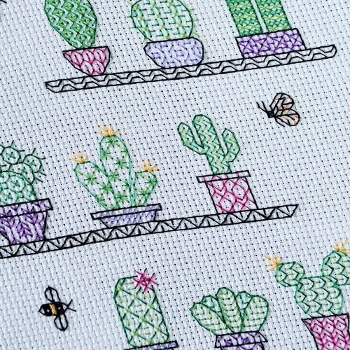 Stitched geometric leaves in shades of purple, blue, pink, yellow