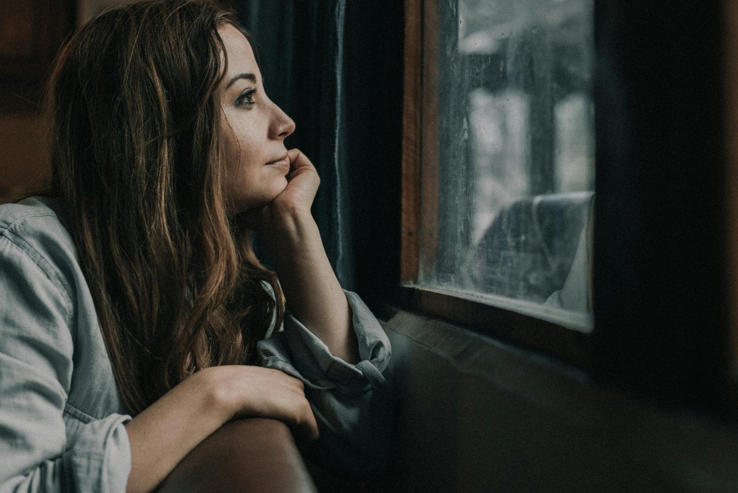 Woman looking thoughtfully out the window
