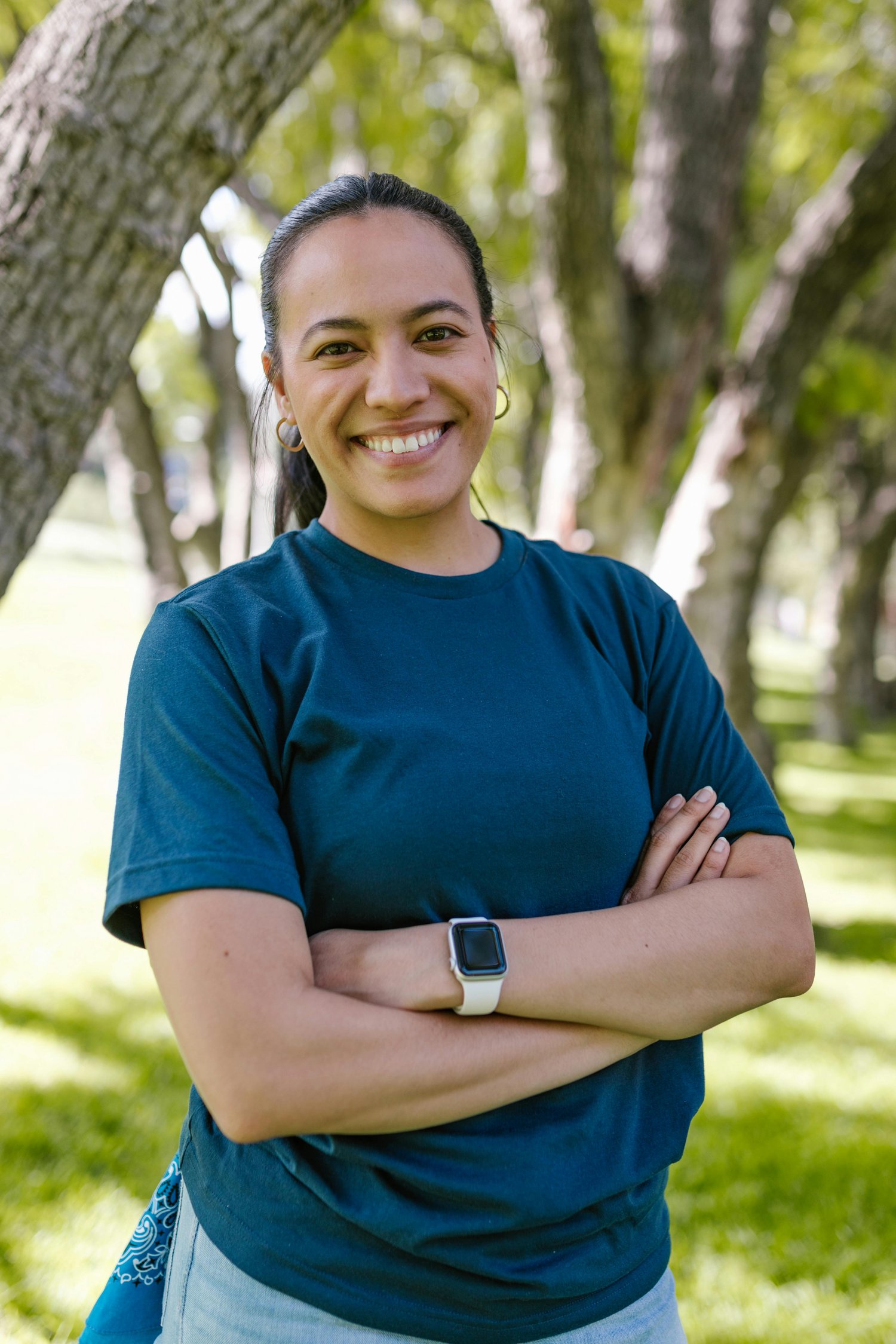 woman standing confidently in nature with a smile