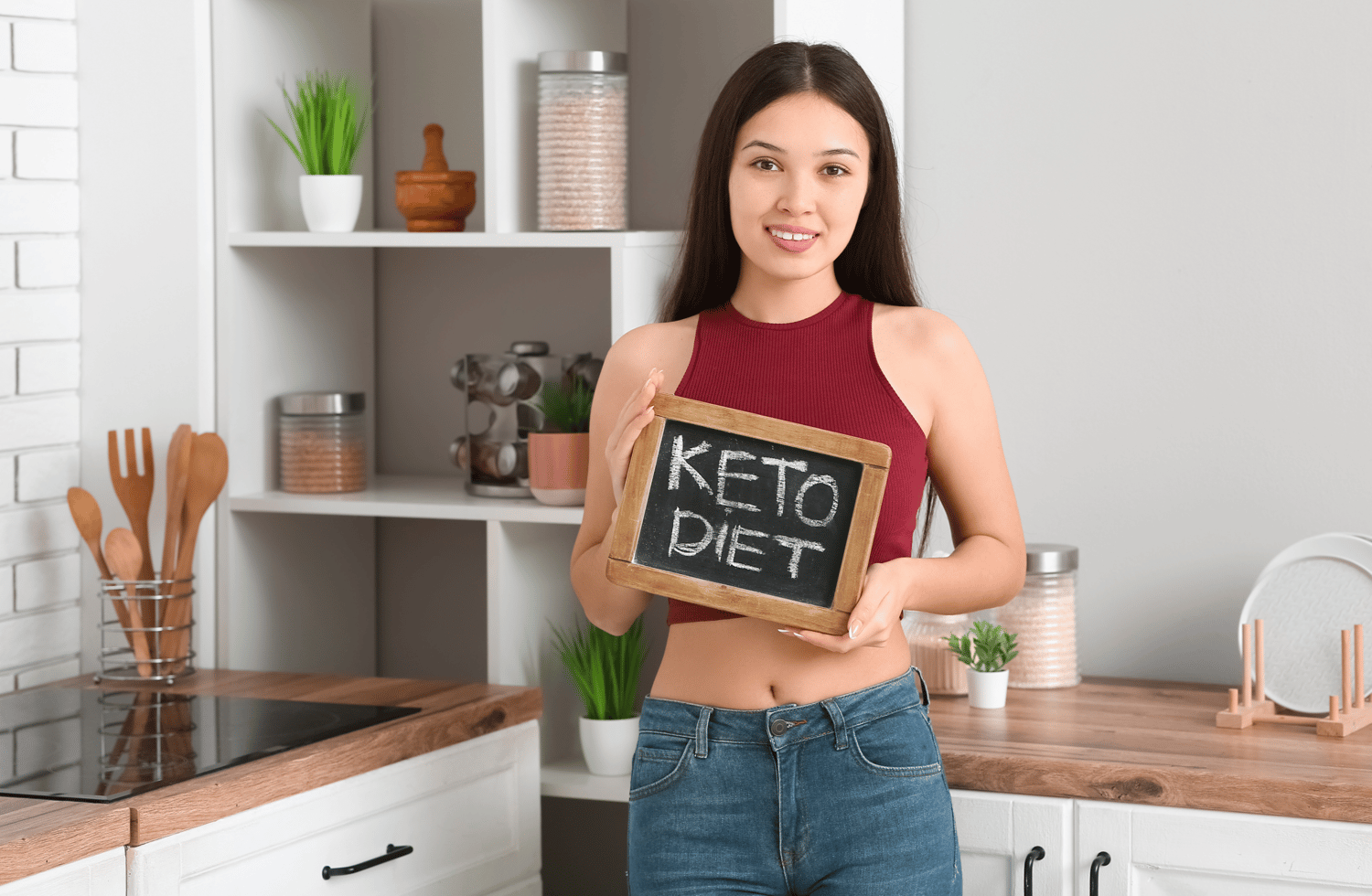 A beautiful Asian woman holds up a sign that says, 