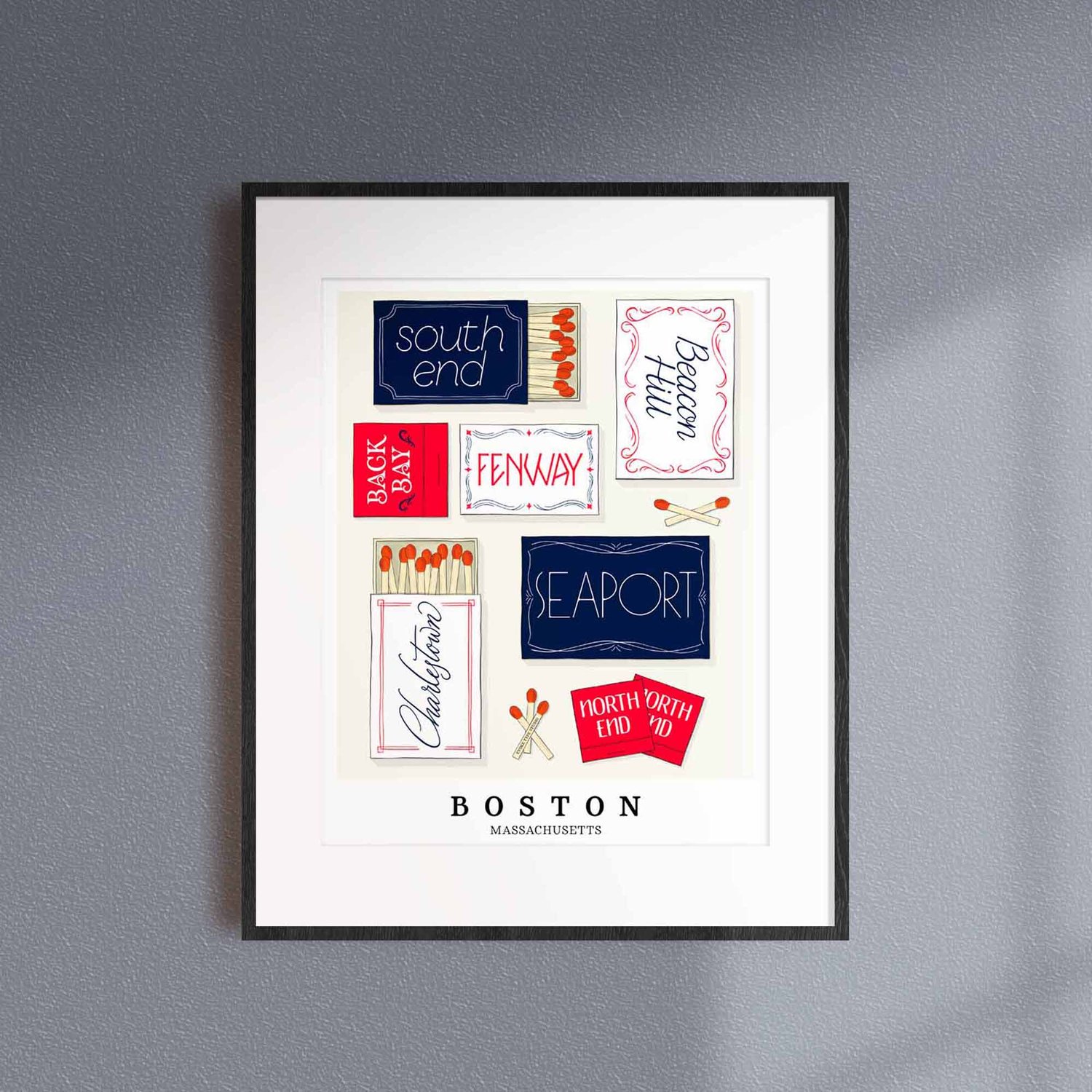 A framed picture of Boston, Massachusetts neighborhoods drawn in various lettering styles on matchboxes. Artwork has a patriotic color scheme of red, white and blue.