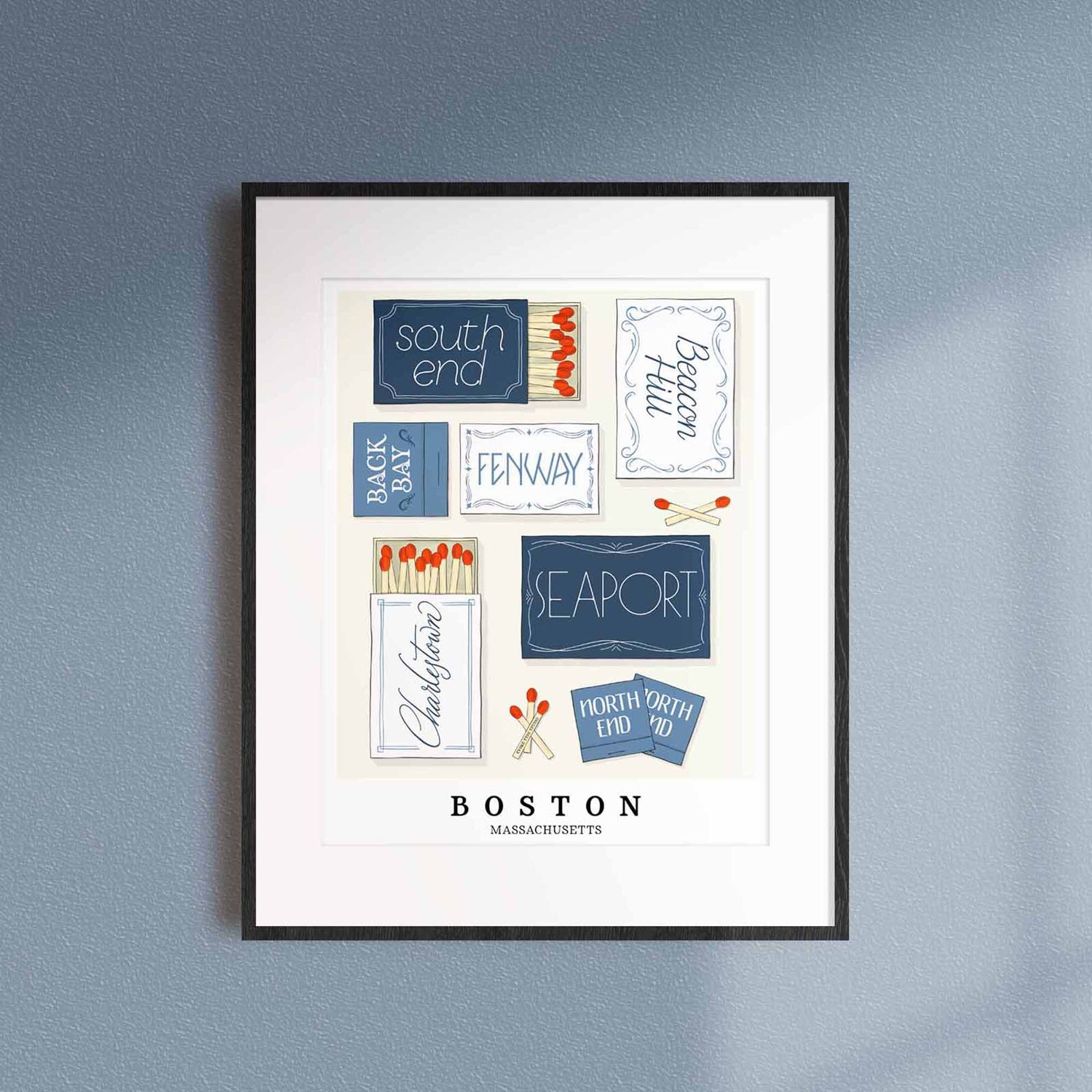 A framed picture of Boston, Massachusetts neighborhoods drawn in various lettering styles on matchboxes. Artwork has a blue and white color scheme.