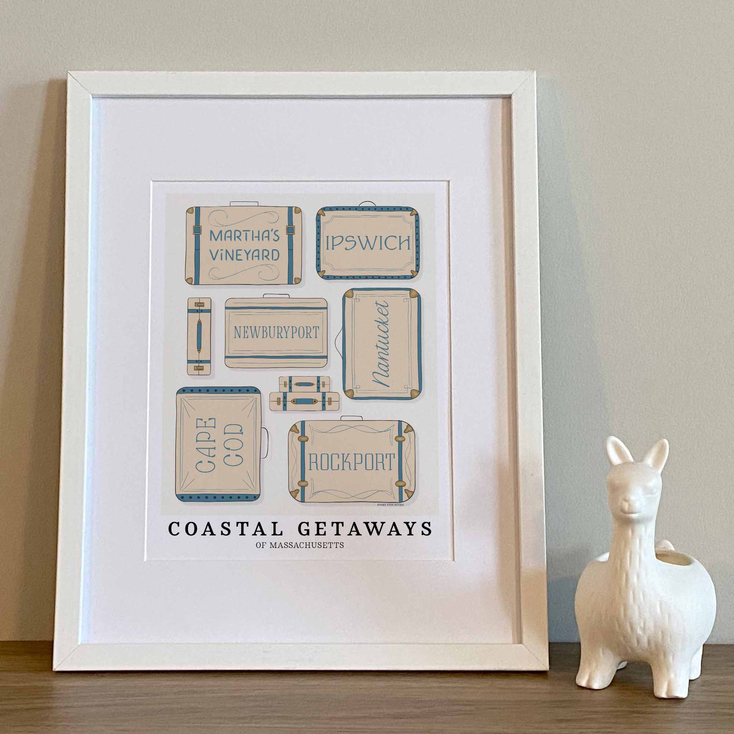 Coastal Massachusetts travel wall art with hand-drawn suitcase illustrations in soft neutral and blue hues.