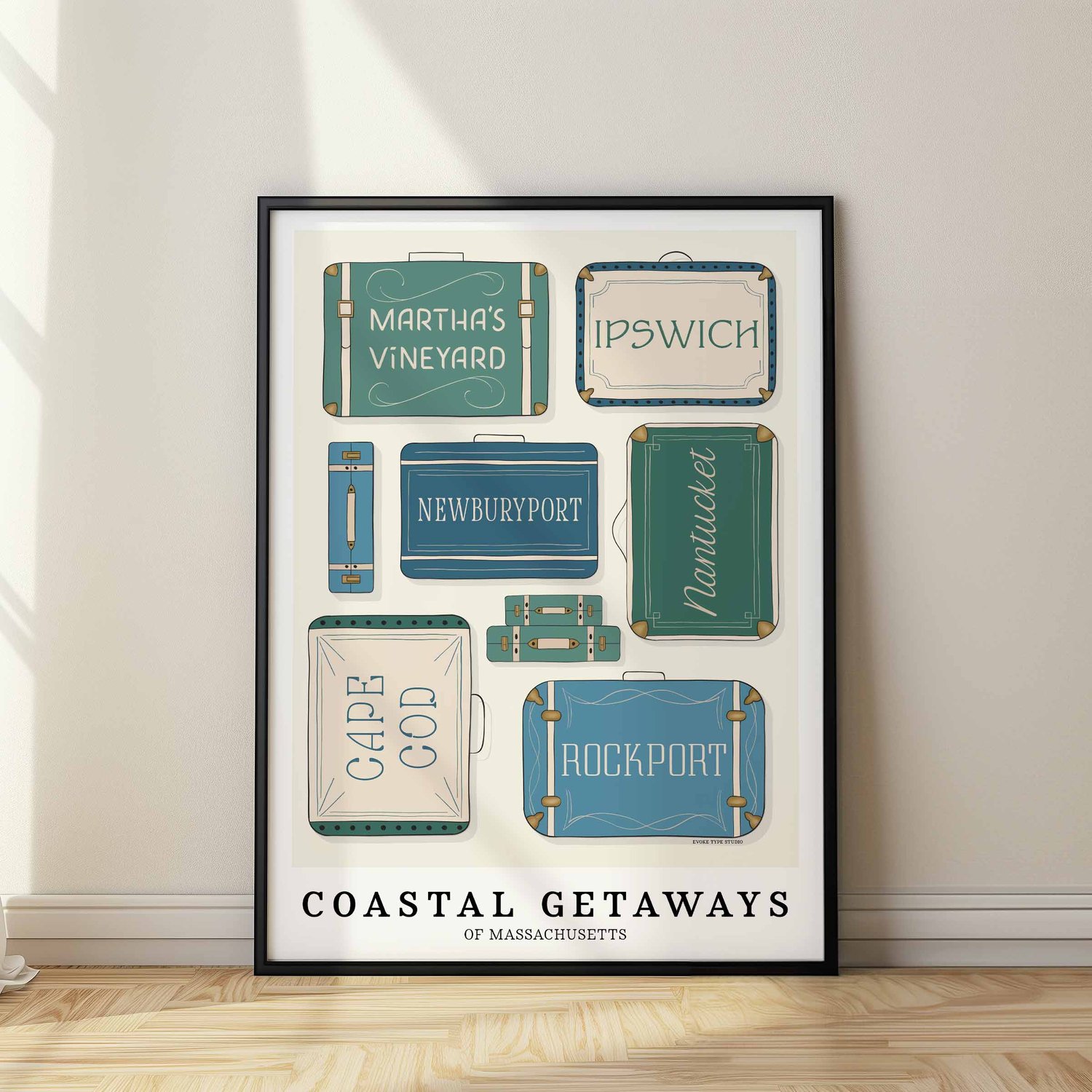 A framed picture of coastal Massachusetts areas drawn in various lettering styles on suitcases. Artwork has a green, blue and beige color scheme