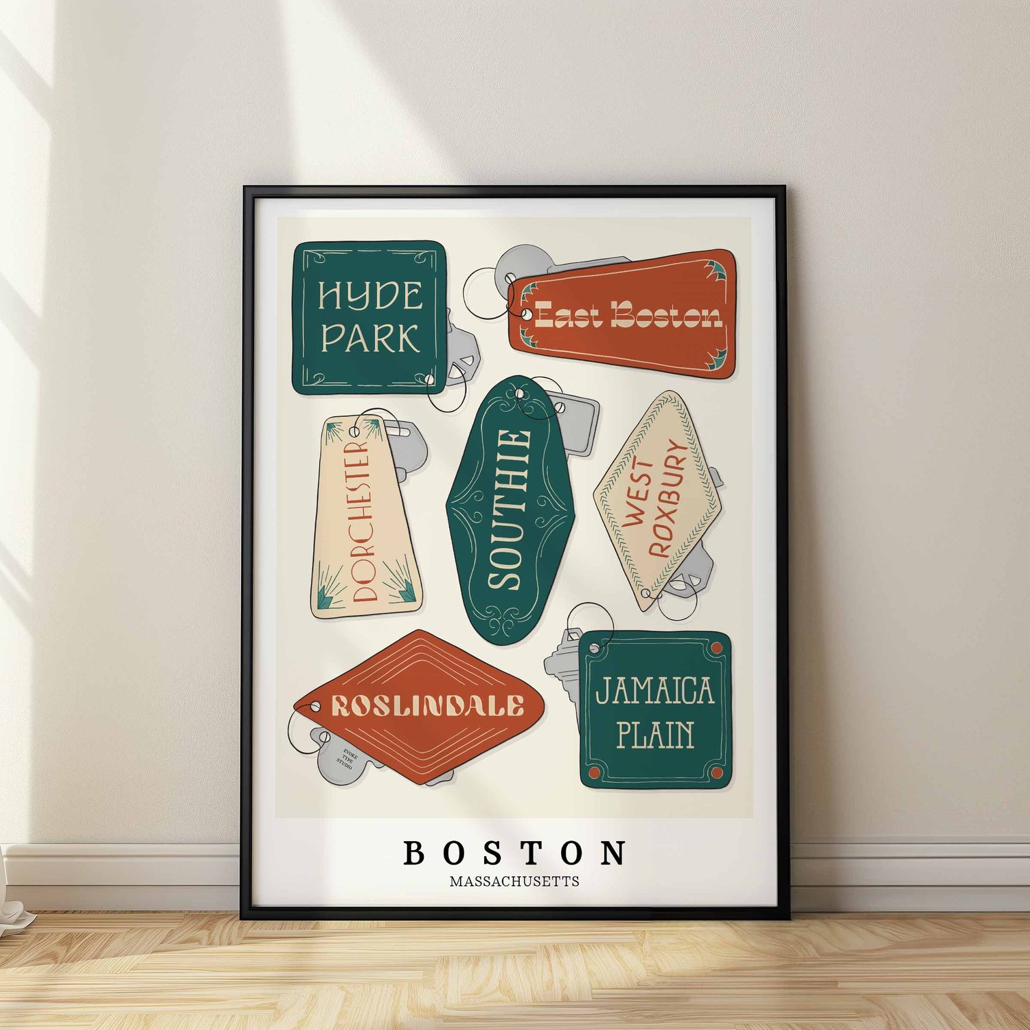 A framed picture of Boston neighborhoods drawn in various lettering styles on key fobs. Artwork has a green, orange and tan color scheme