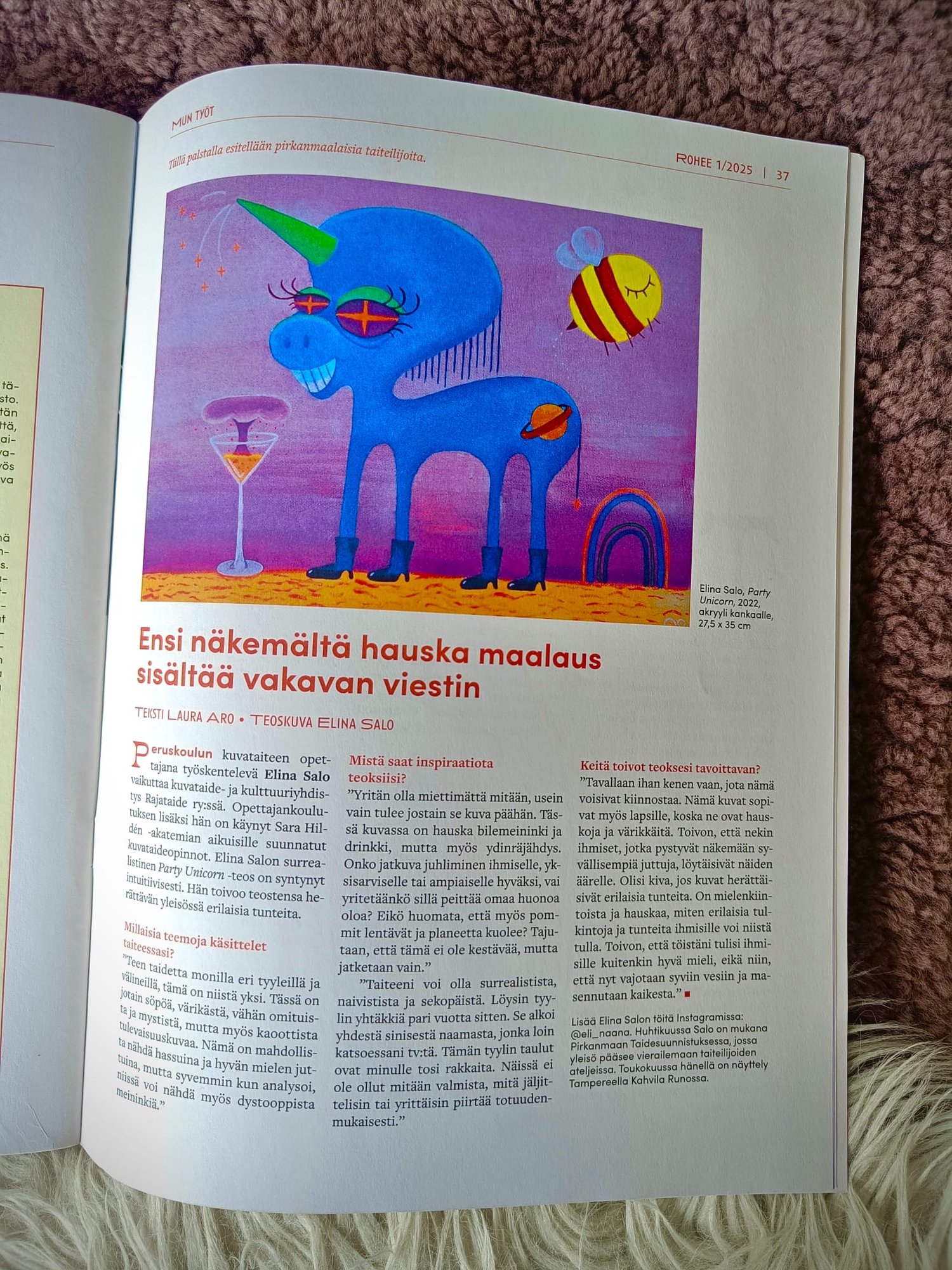 A picture of an article in a magazine. Article is about a surrealistic acrylic painting by Elina Salo and the meaning behind it.