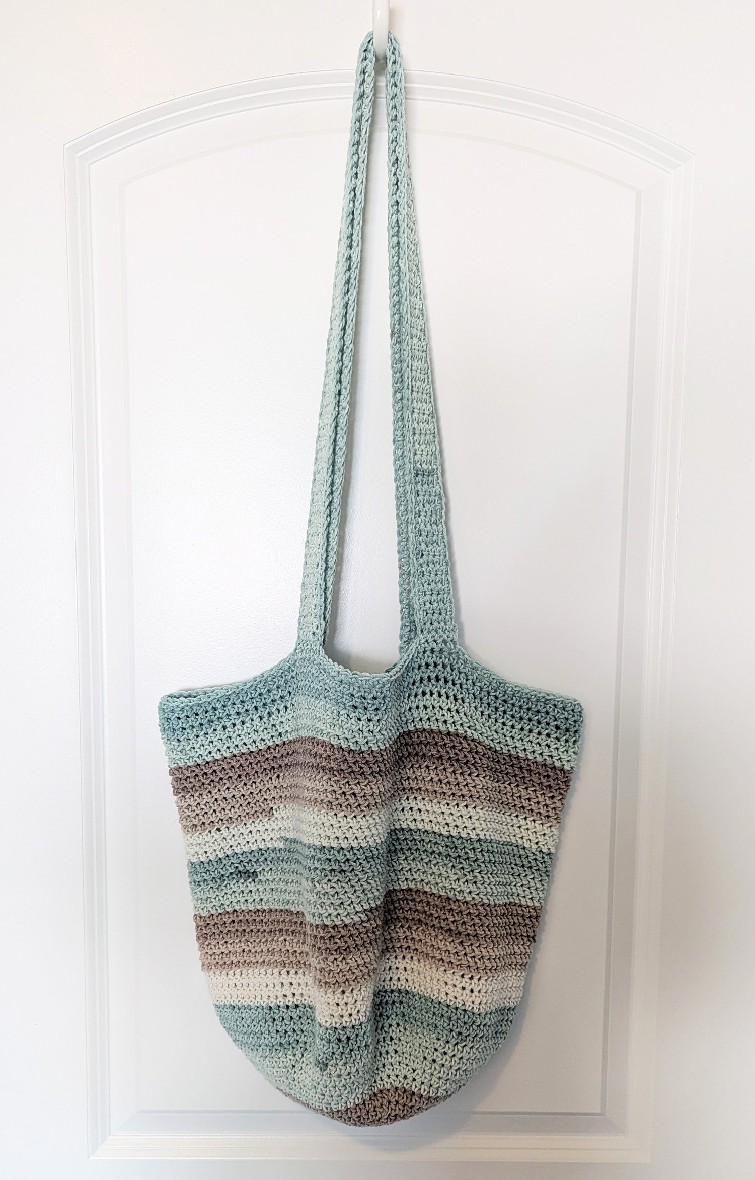 Seaside Tote Crochet Pattern Hanging from Door
