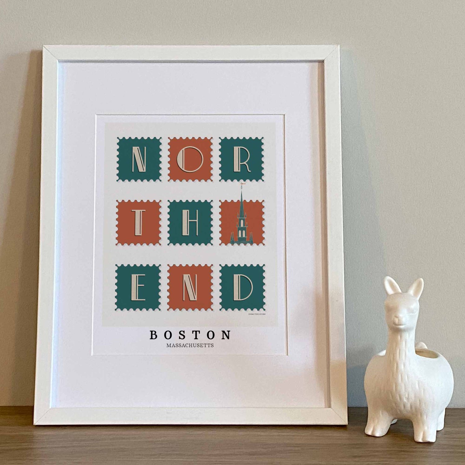 Hand-drawn North End wall art featuring a postage stamp-style design with art deco lettering and an Old North Church illustration.