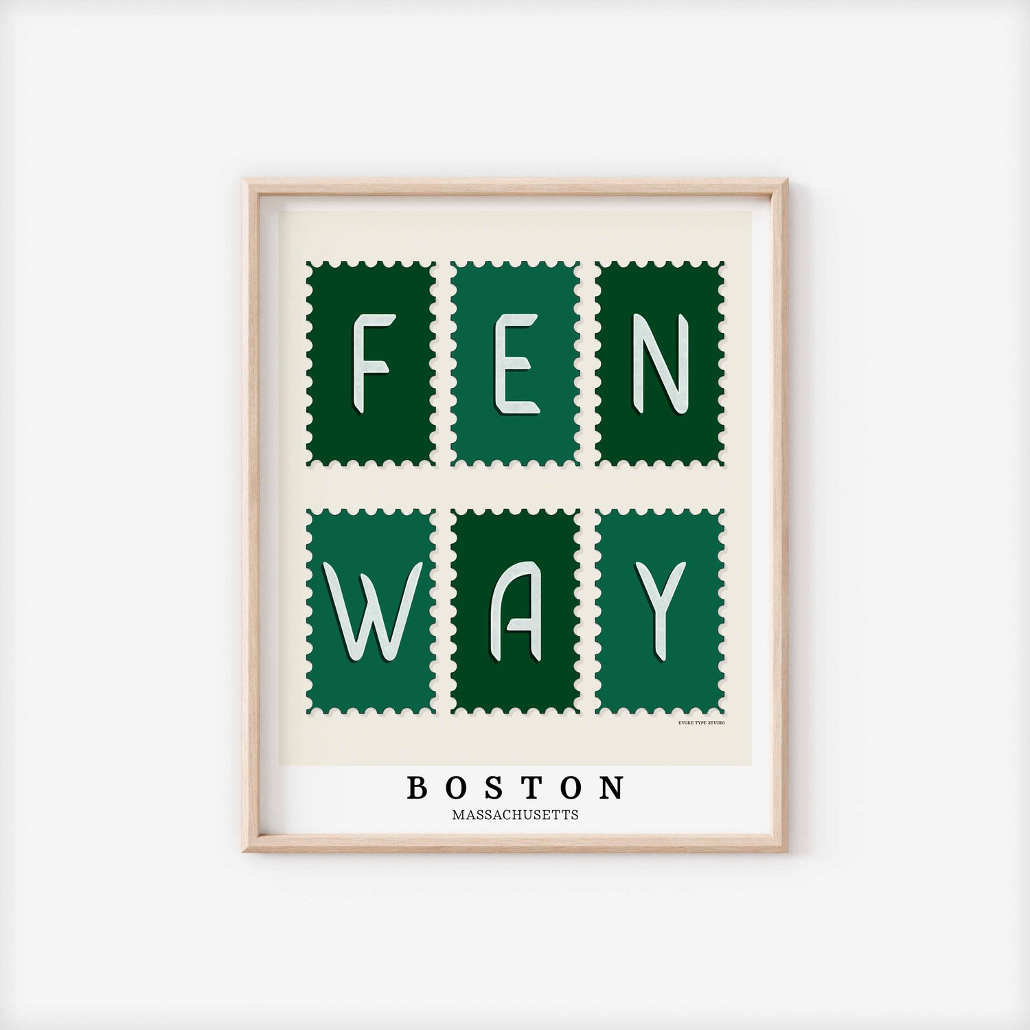 A framed picture of postage stamps featuring the Fenway neighborhood in Boston, Massachusetts drawn in a unique lettering style. Artwork has a green and white color scheme