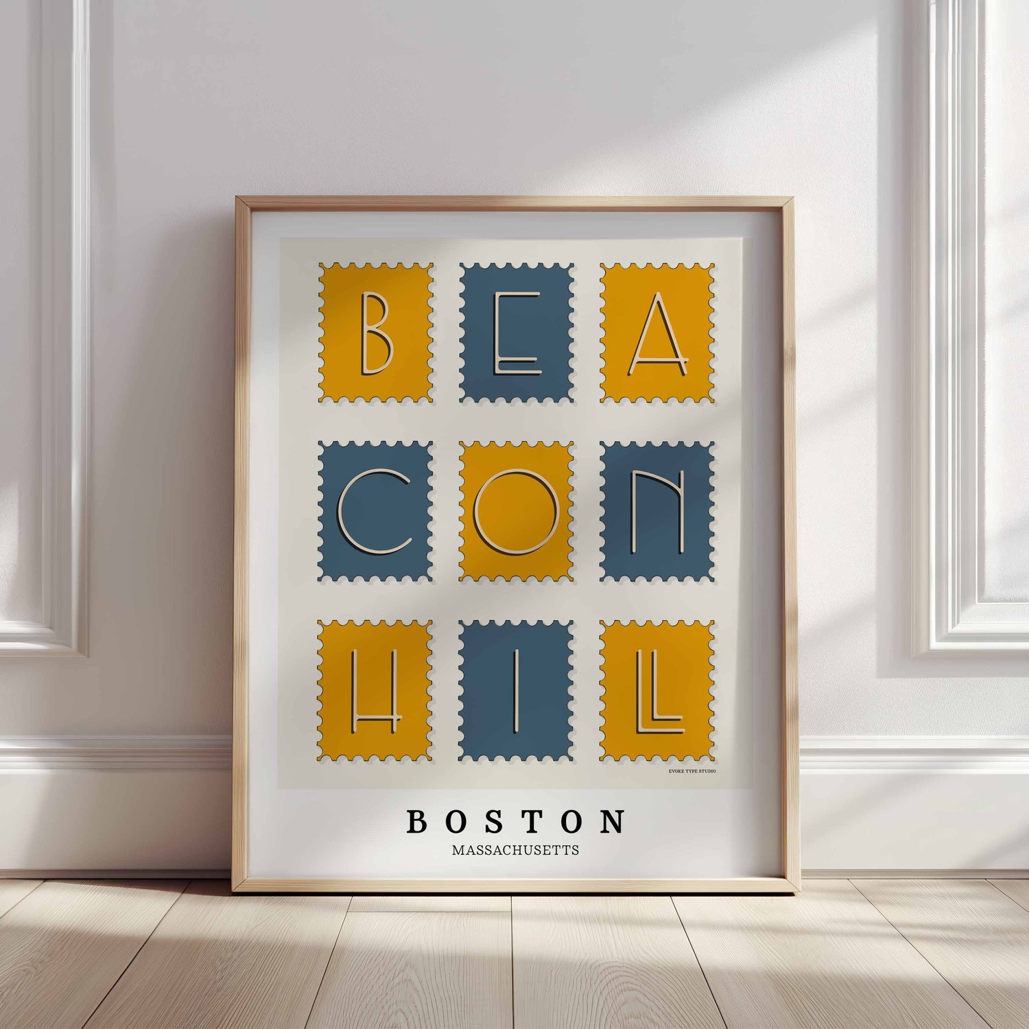 A framed picture of postage stamps featuring the Beacon Hill neighborhood in Boston, Massachusetts drawn in a unique lettering style. Artwork has a blue and yellow color scheme