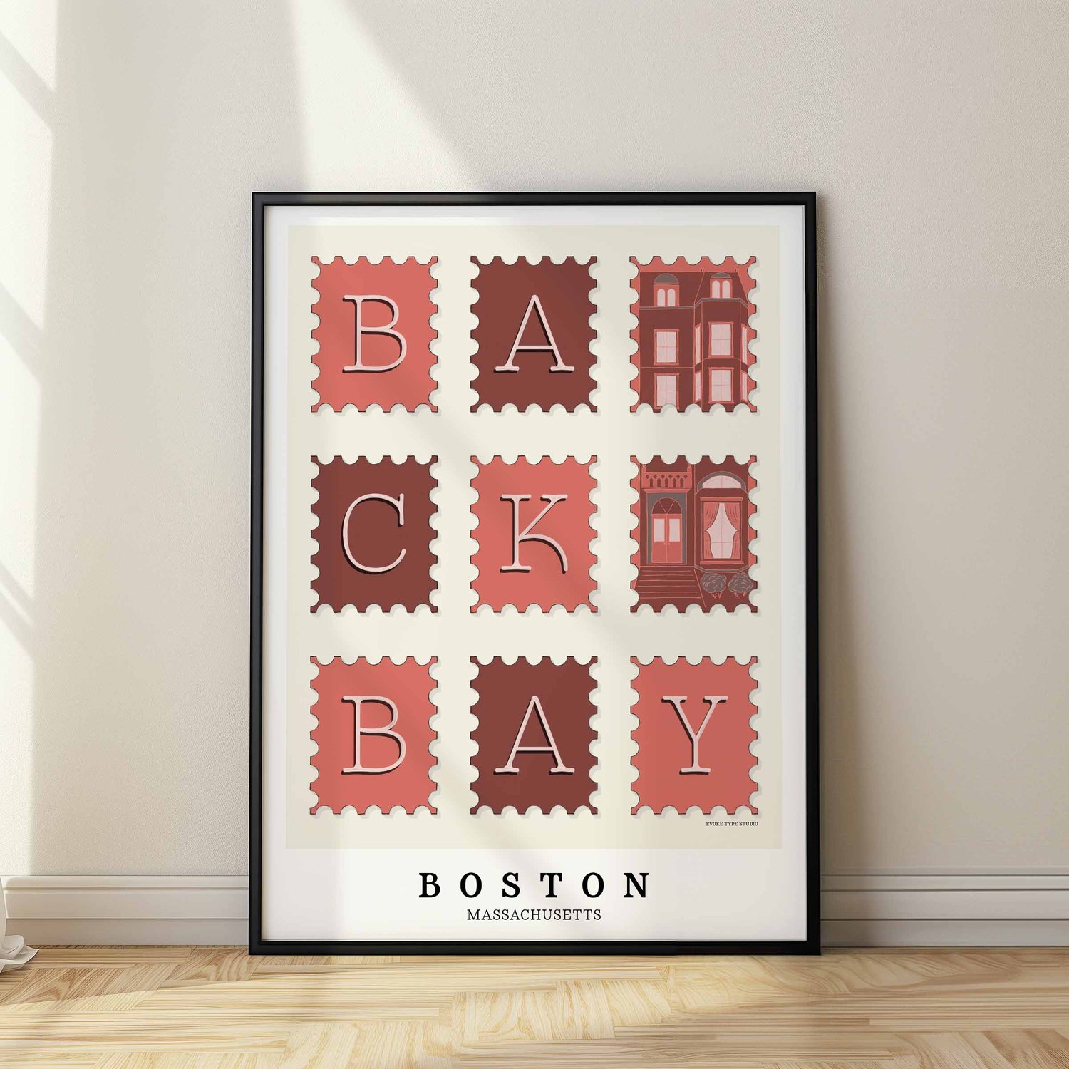A framed picture of postage stamps featuring the Back Bay neighborhood in Boston, Massachusetts drawn in a unique lettering style. Artwork has a pink, burgundy and gray color scheme