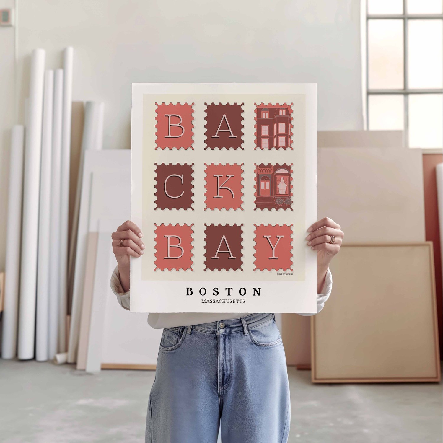 A person holding a poster of several postage stamps